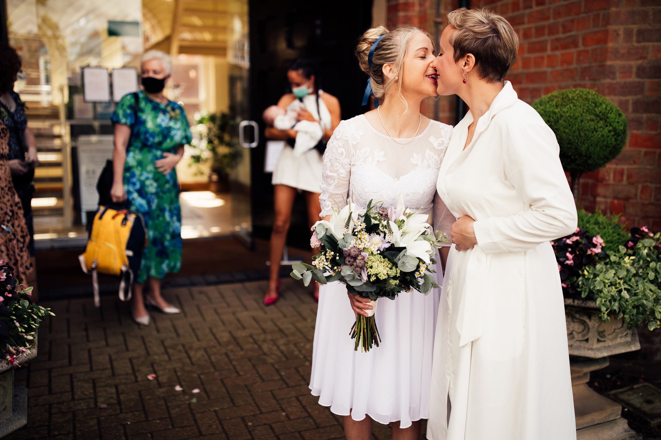 same sex couple kiss outside registry office