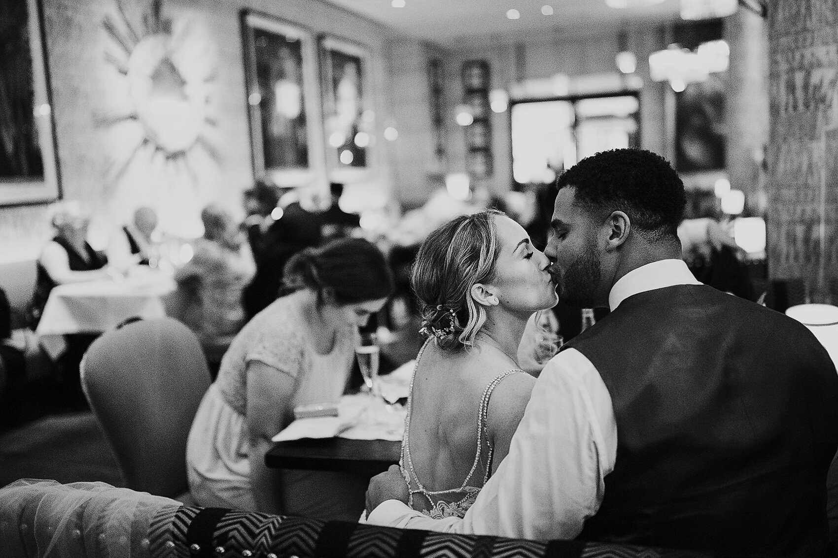 couple kiss after speeches at London wedding