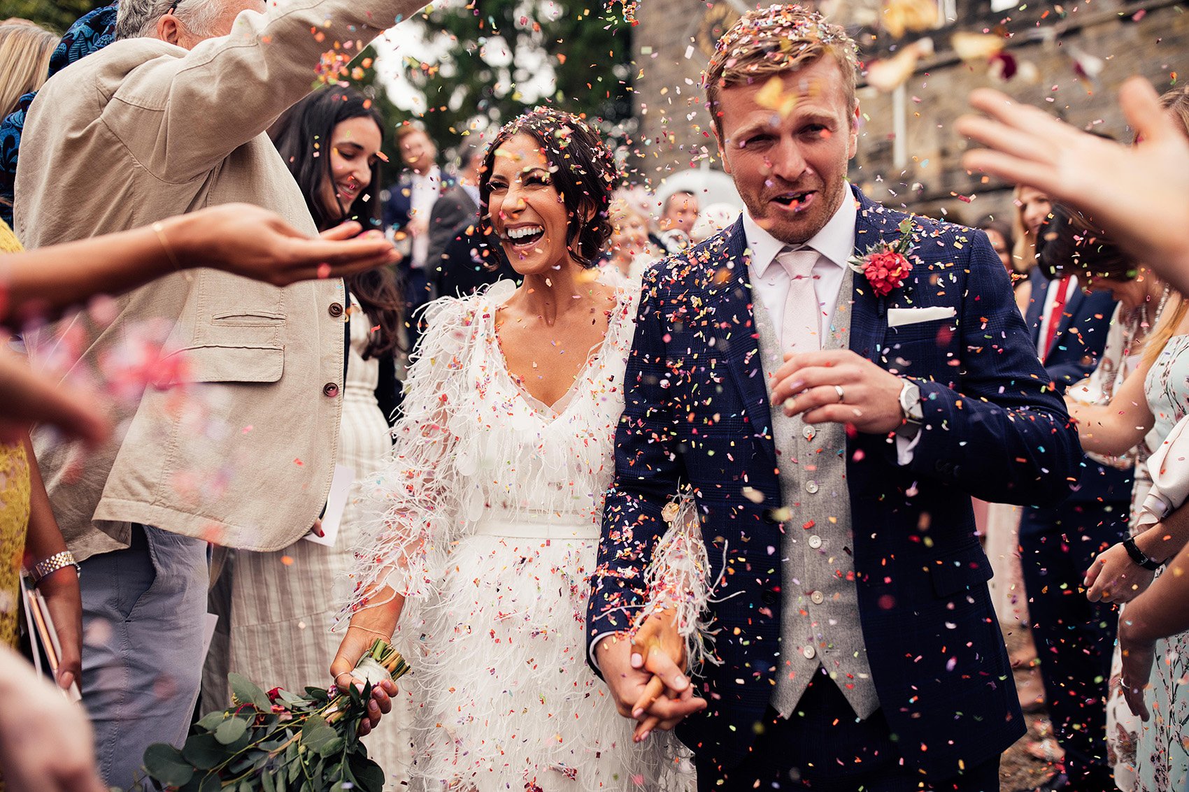 Confetti Exit with Bride in Feather Wedding Dress and Groom in Three Piece Suit