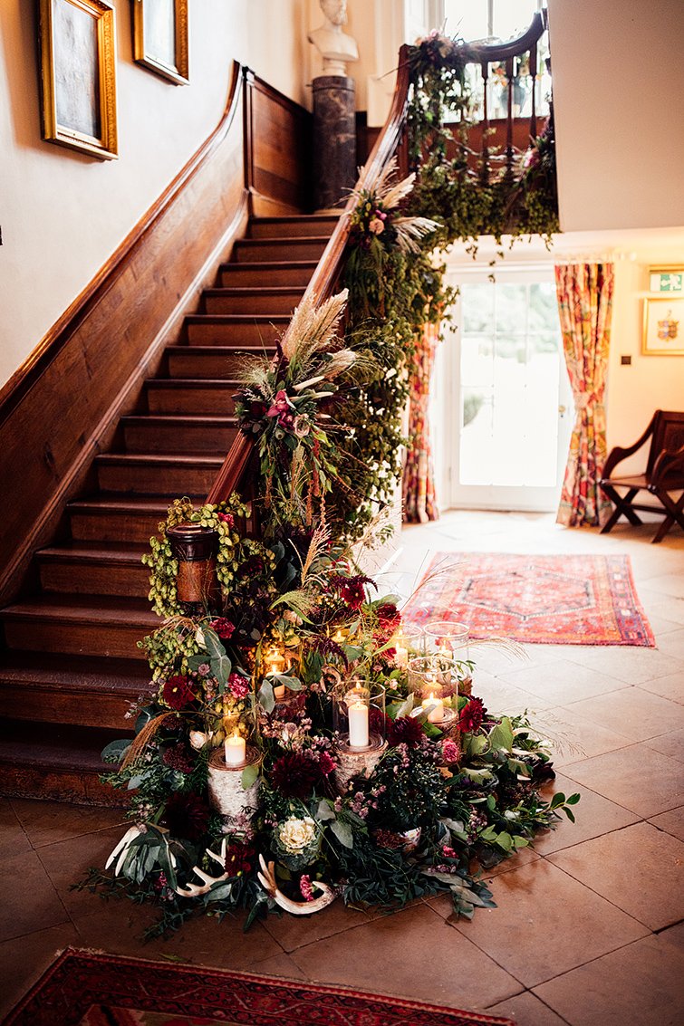 floral staircase with roses, pampas grass and deer antlers 