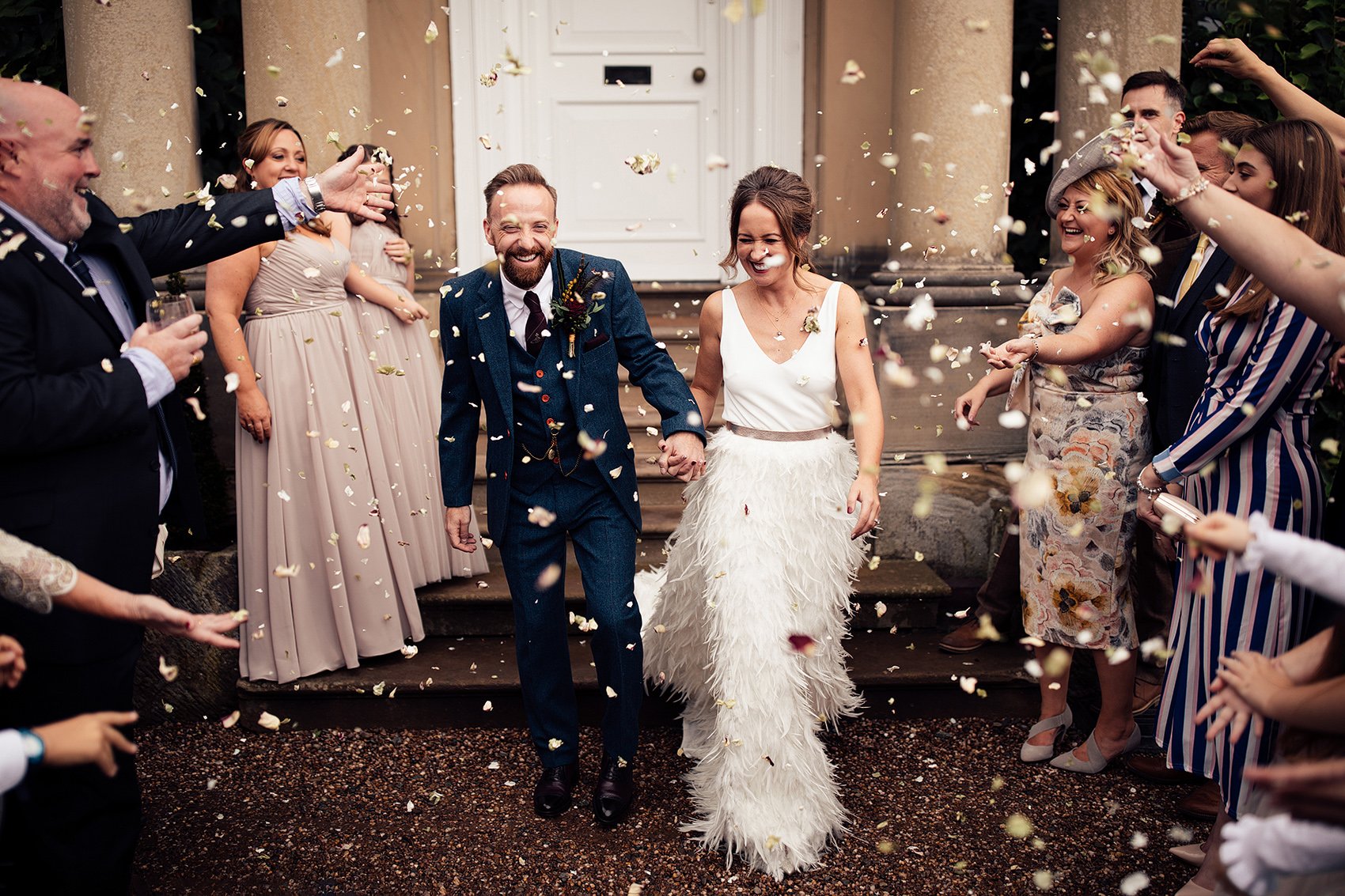 confetti moment with bride in bride in Charlie Brear Payton gown &amp; Piora feather skirt
