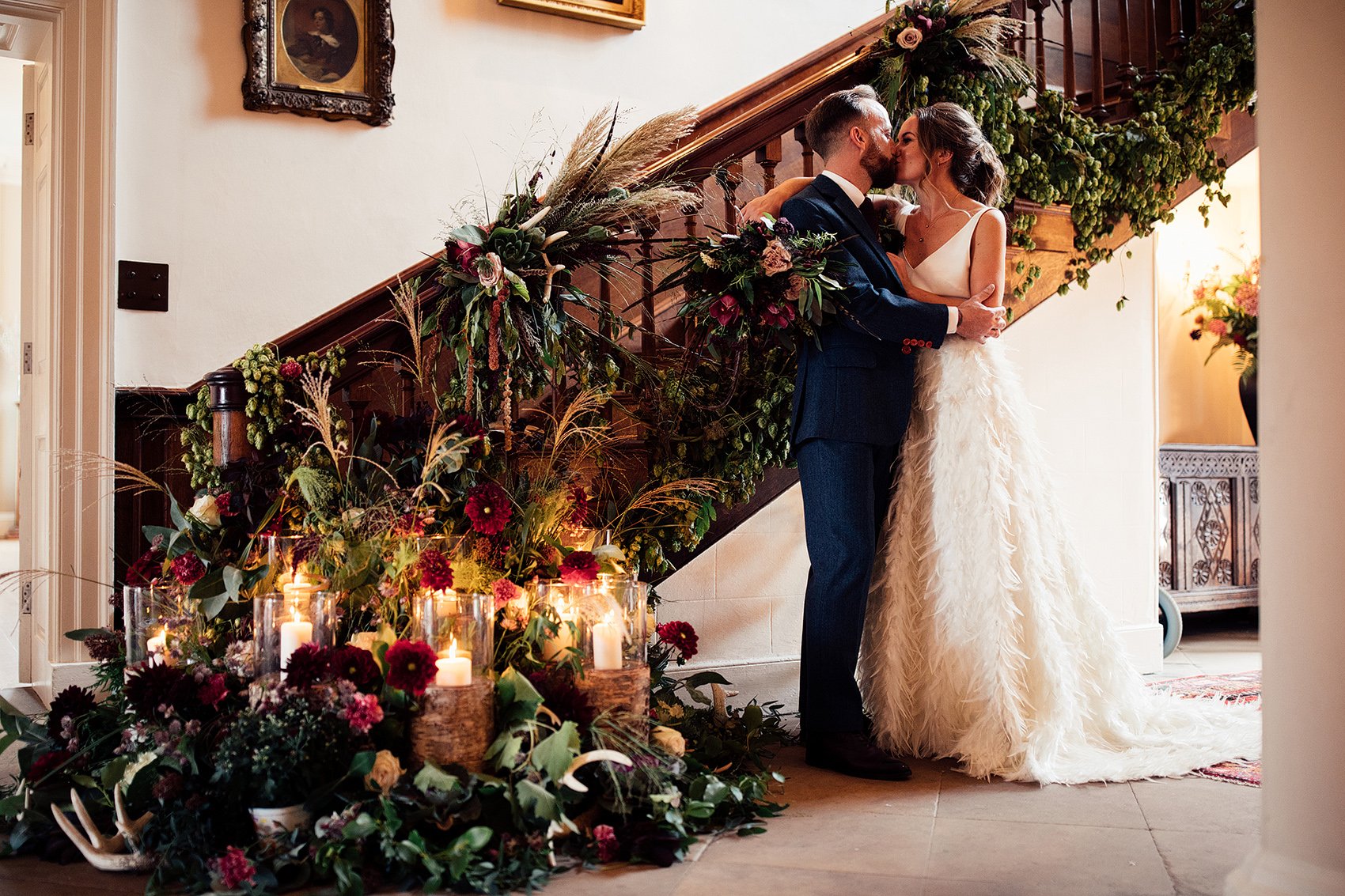 couple kiss by floral staircase