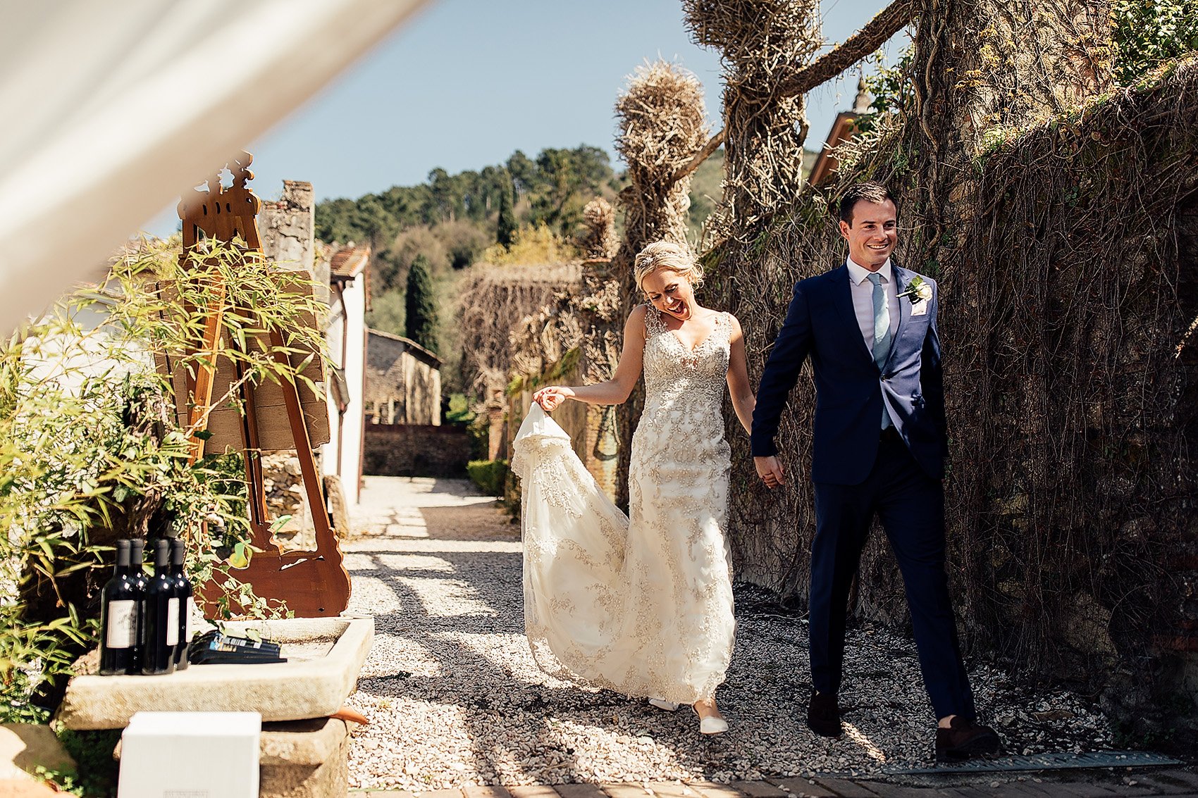 couple enter outdoor wedding reception in Tuscany 