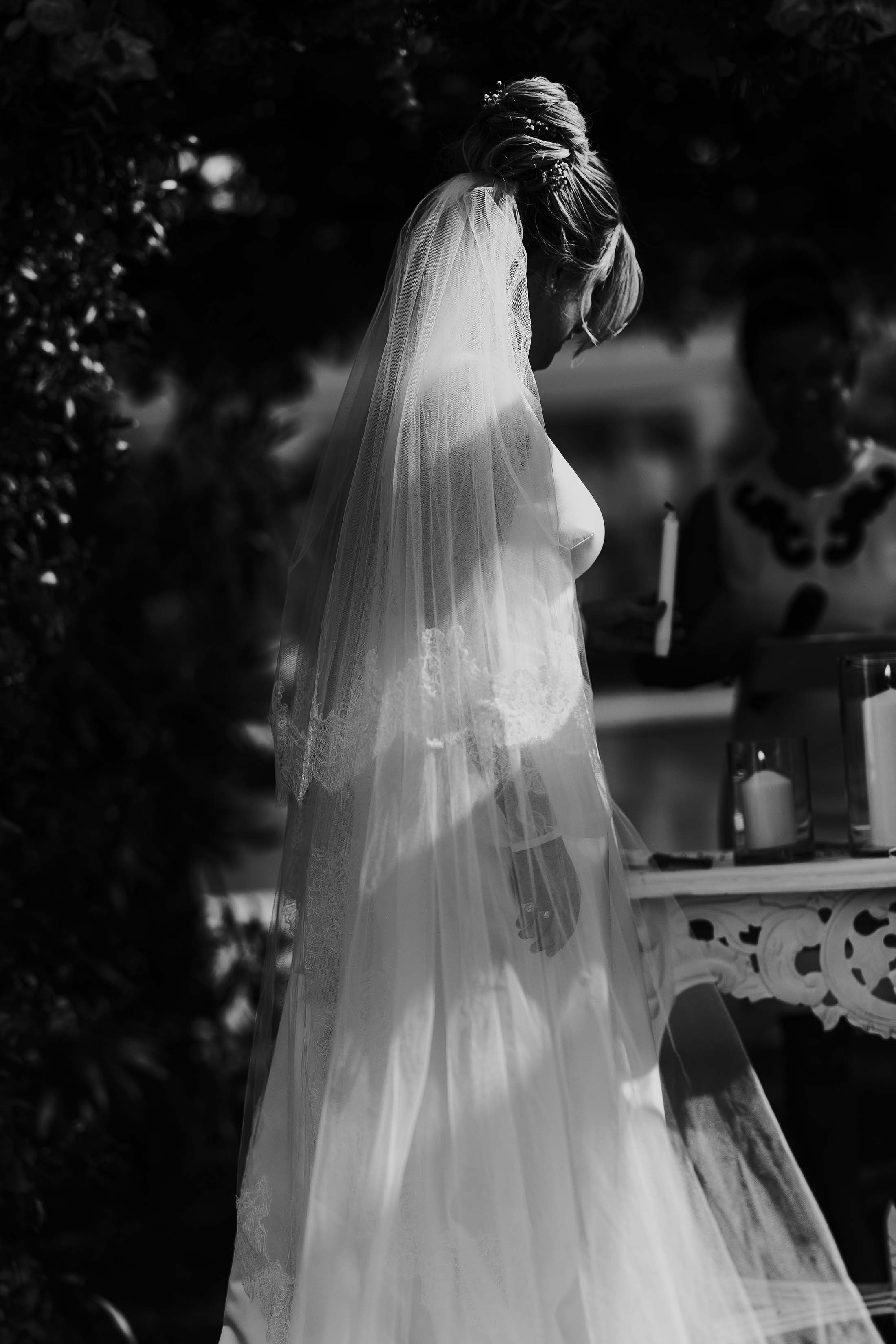 black and white photo of bride in blusher veil
