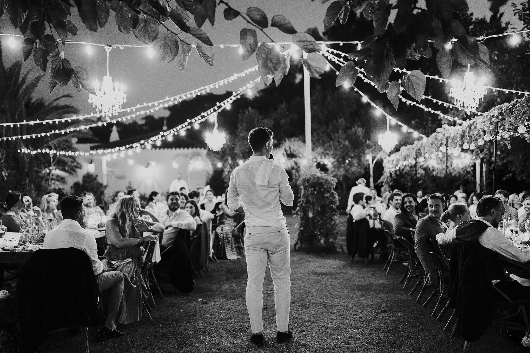 groom delivers speech at outdoor dinner at finca monasterio wedding venue 
