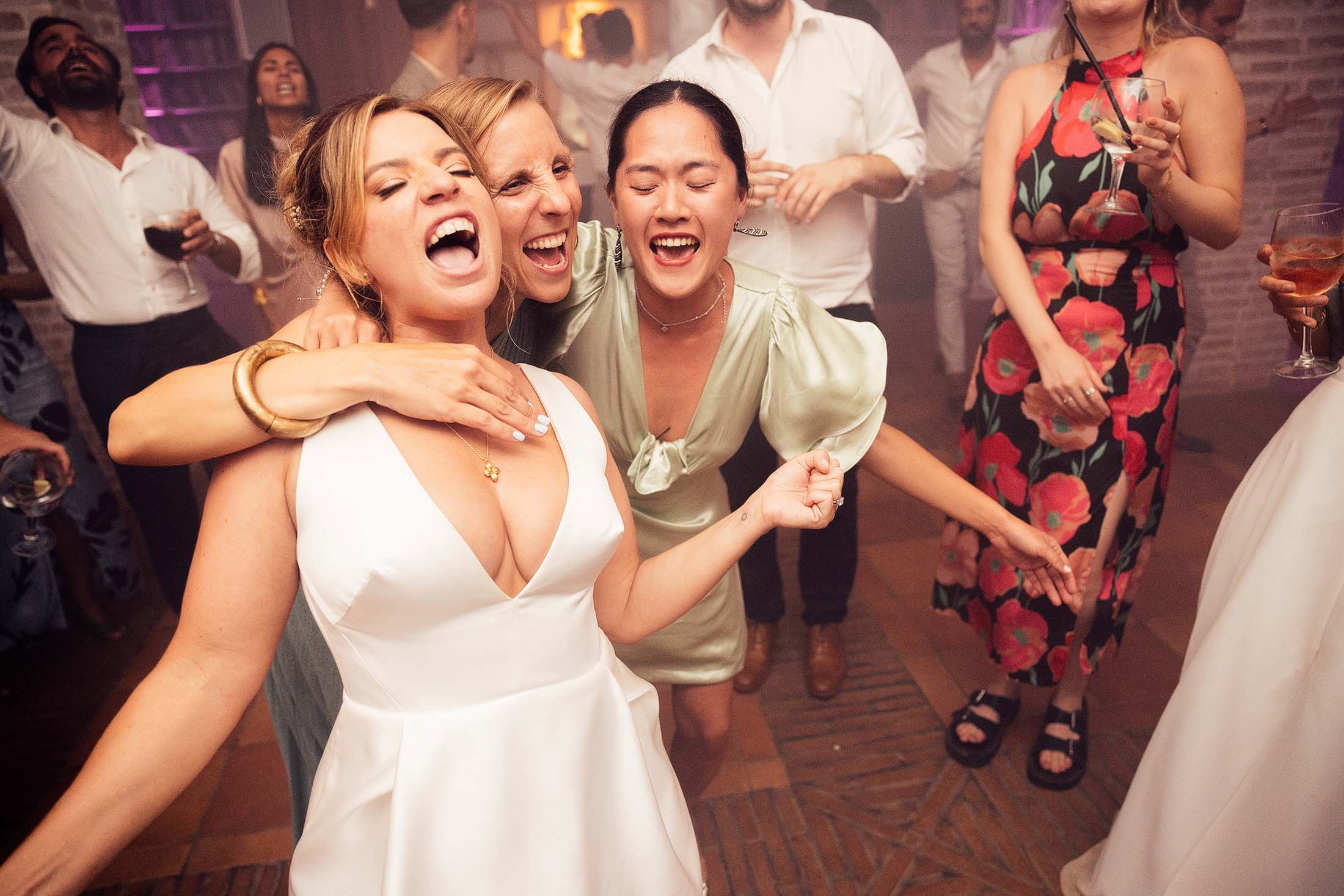 bride sings with friends on dancefloor at finca monasterio wedding venue 