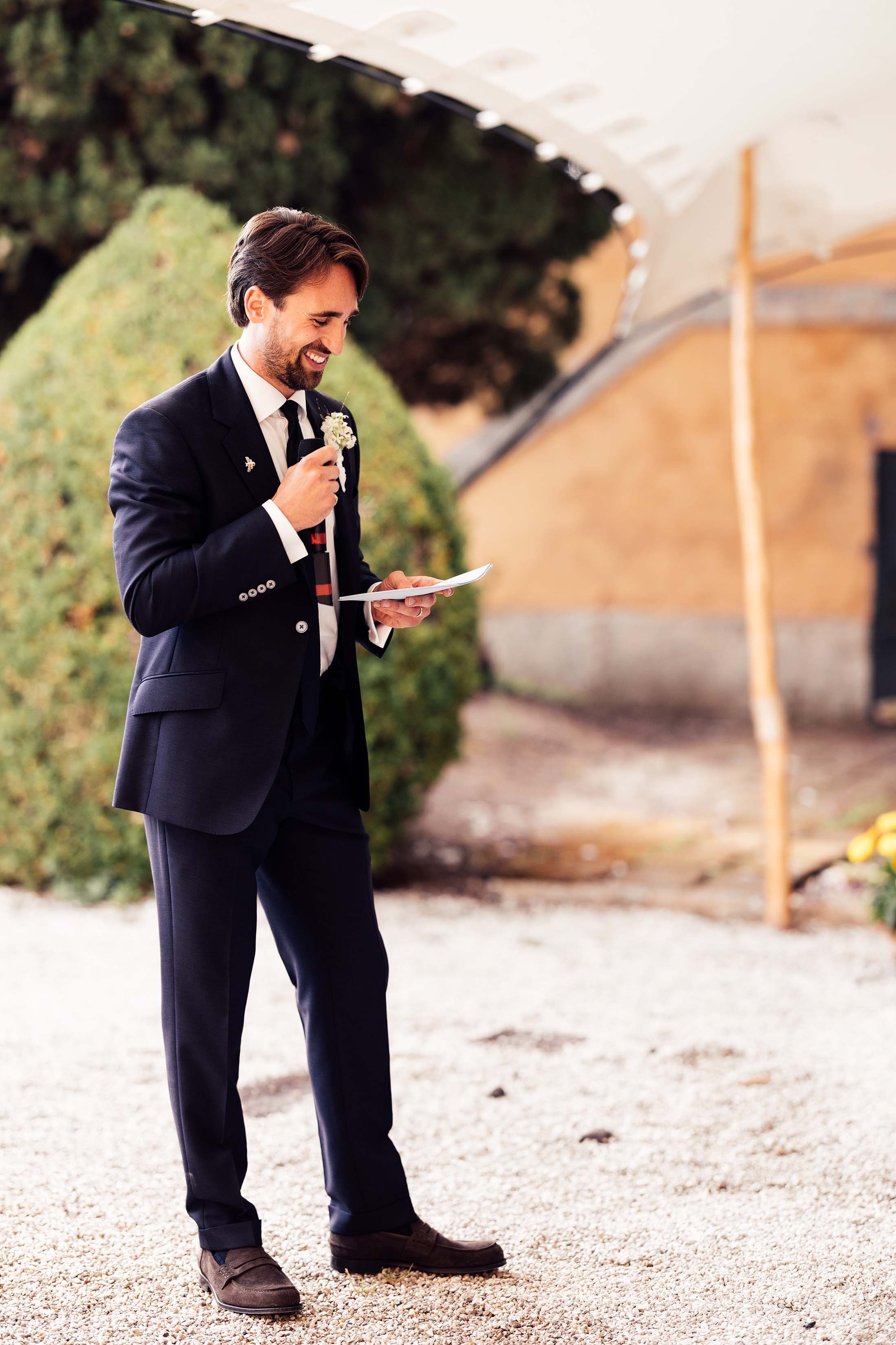 groom delivers speech at outdoor italian wedding reception