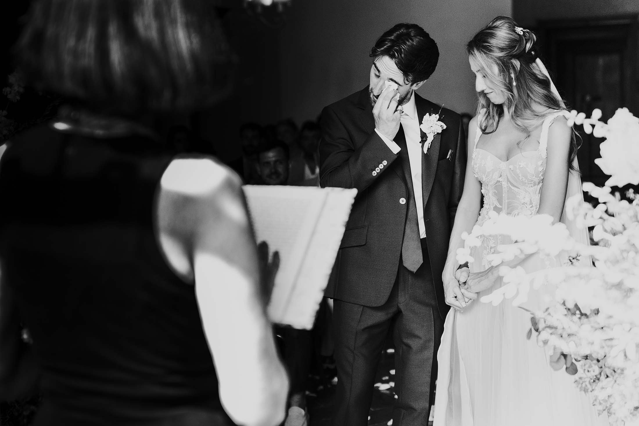 groom cries seeing bride at Italian wedding ceremony at villa di ulignano