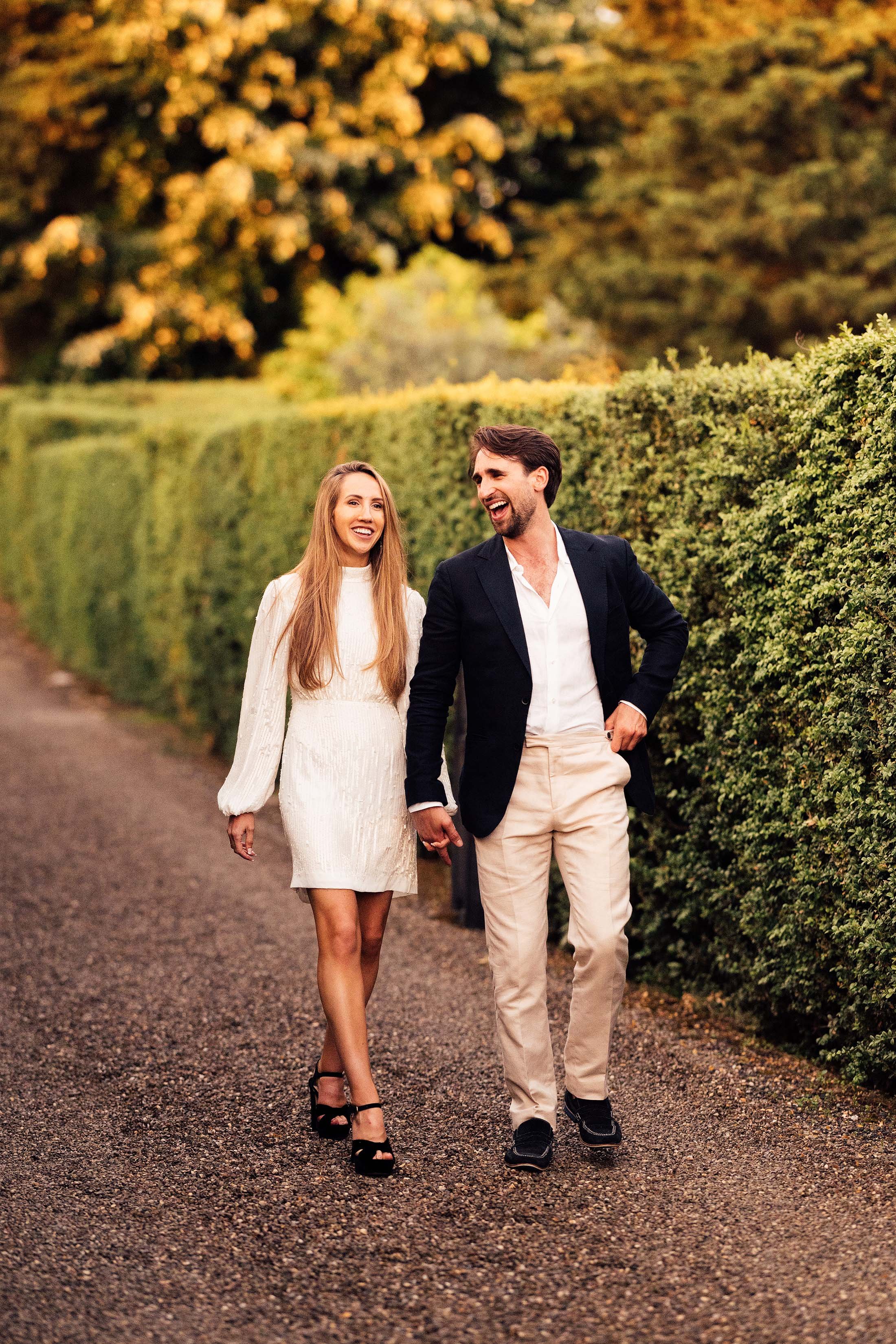 couple walk outside villa di ulignano with bride in rixo dress