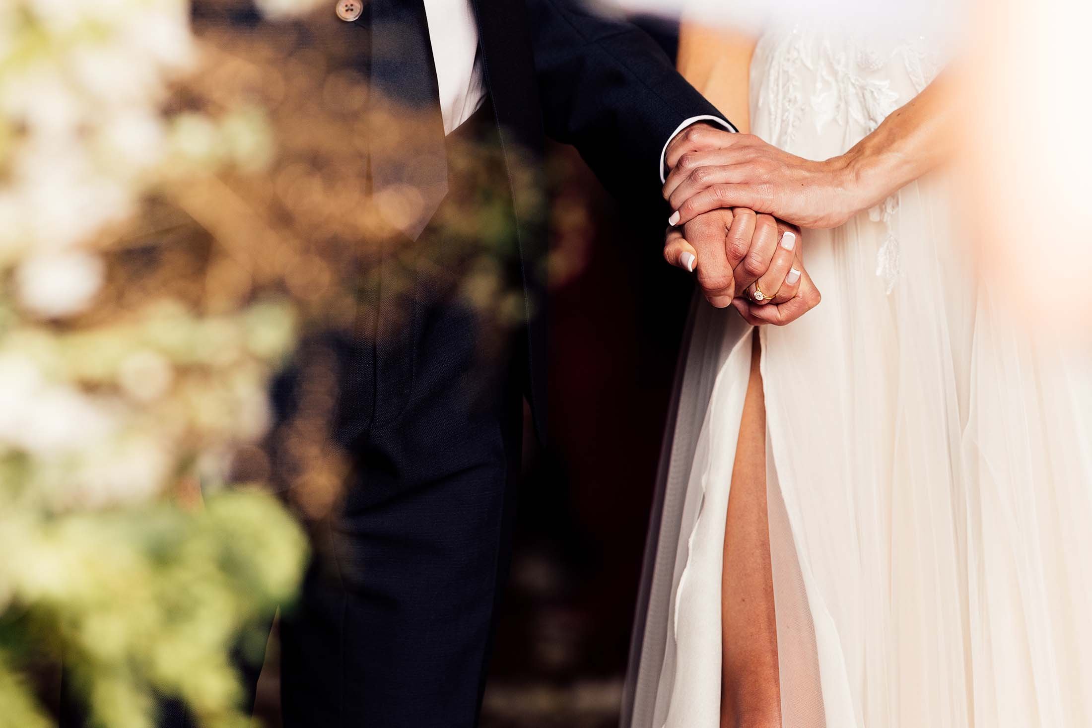 close up on couple holding hands during wedding ceremony at villa di ulignano