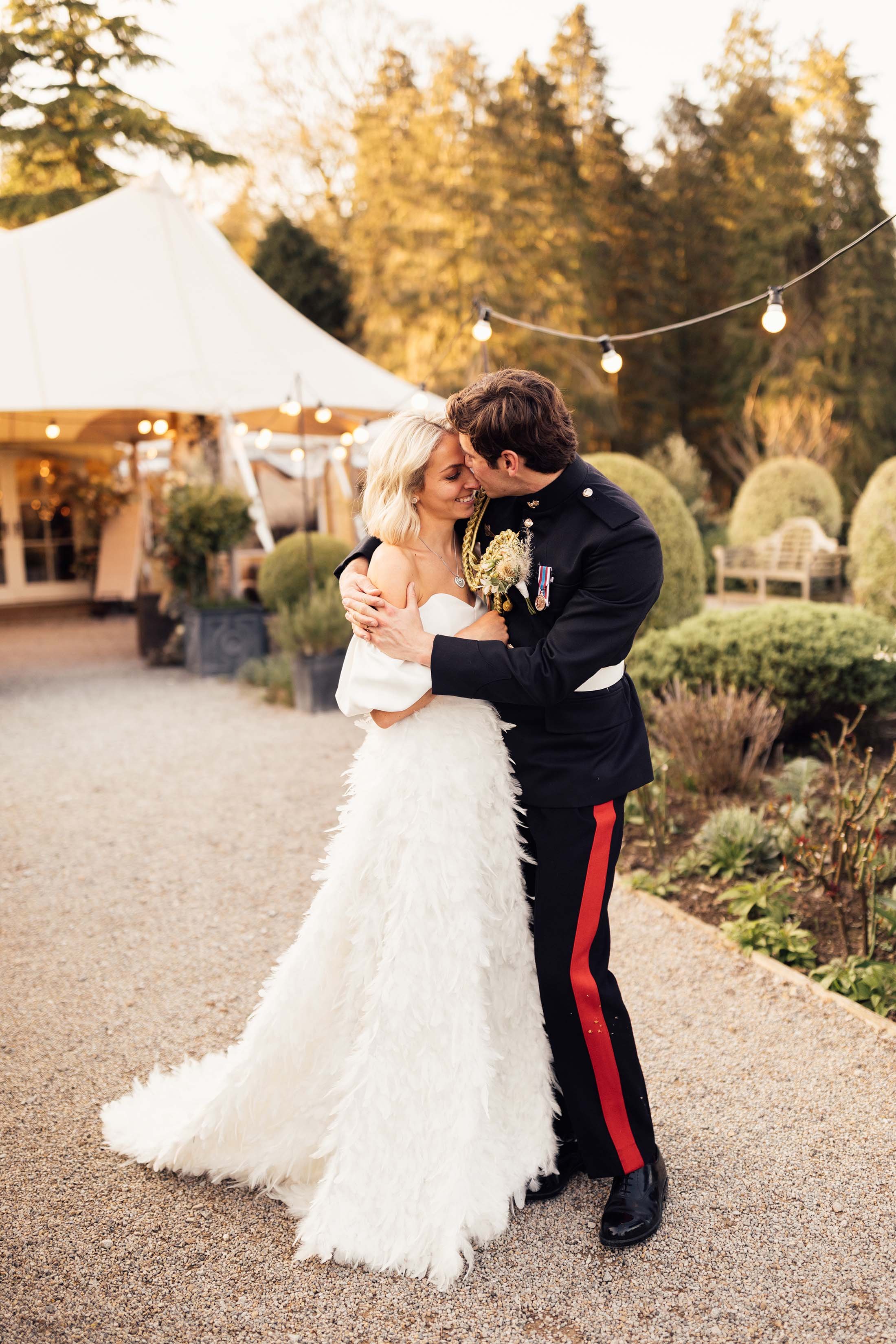 bride in Charlie brear piora feather skirt and groom in military suit