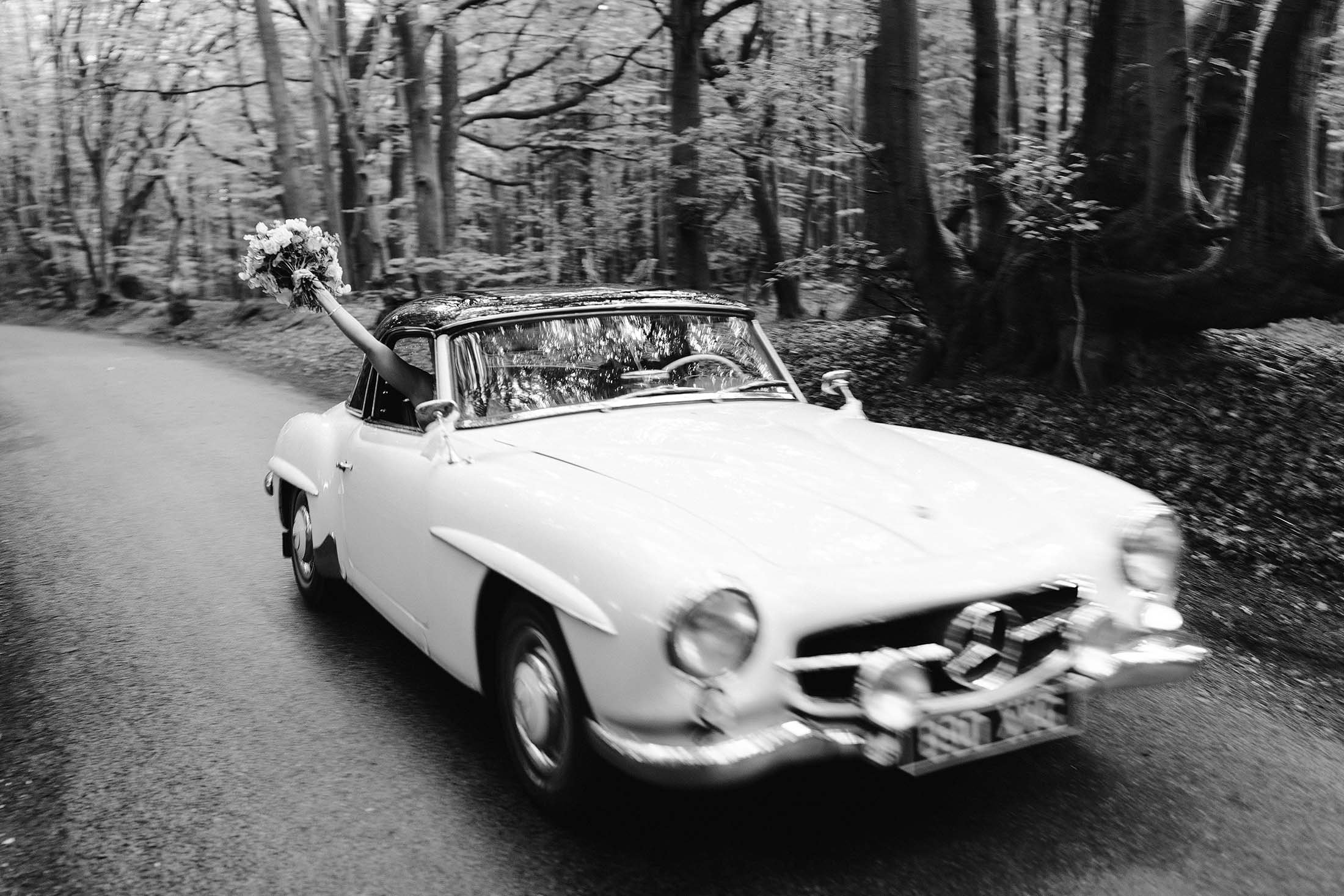 couple ride in vintage Mercedes after wedding in Buckinghamshire