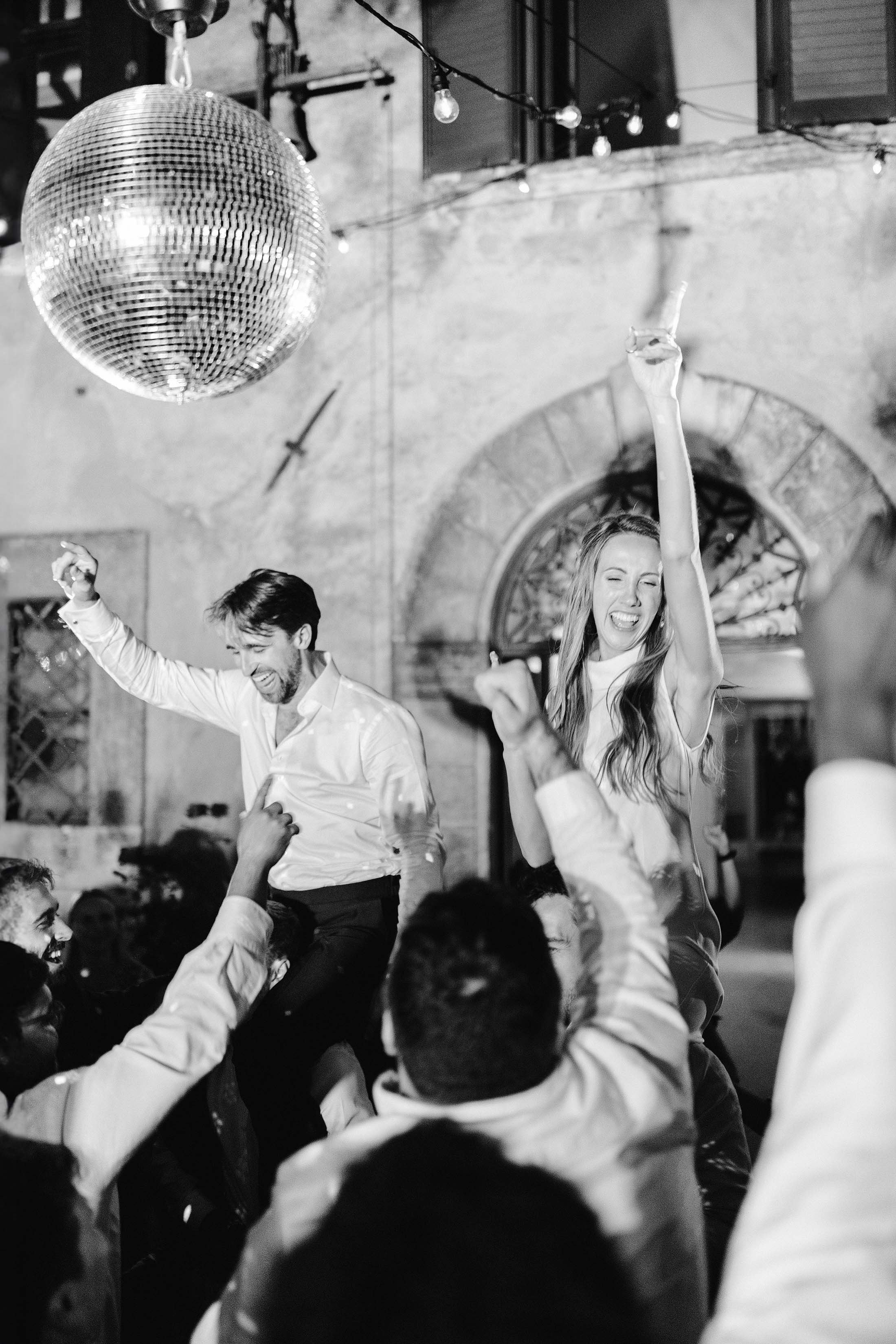 bride and groom lifted on dancefloor at villa di ulignano wedding