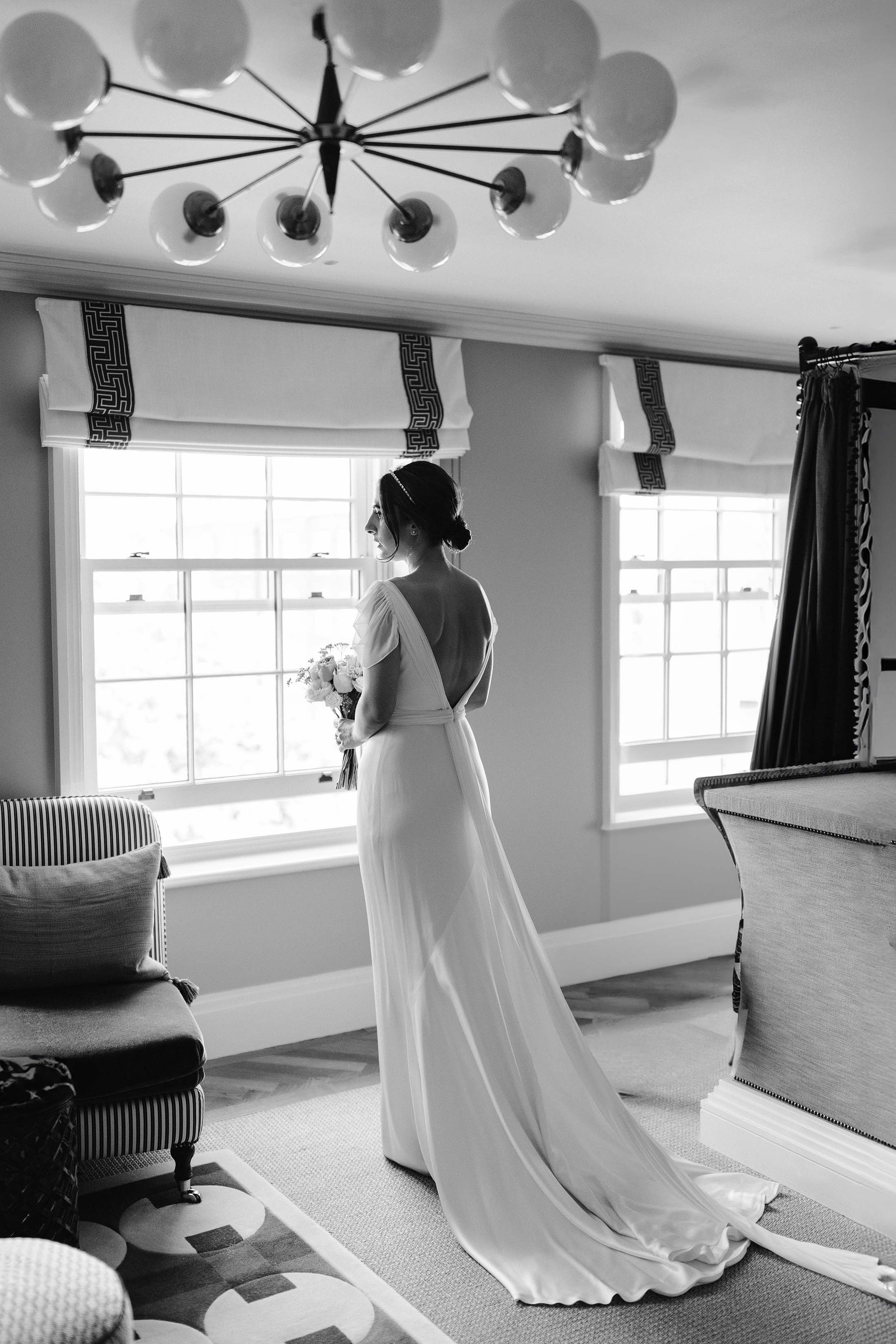 bride poses in savannah miller dress
