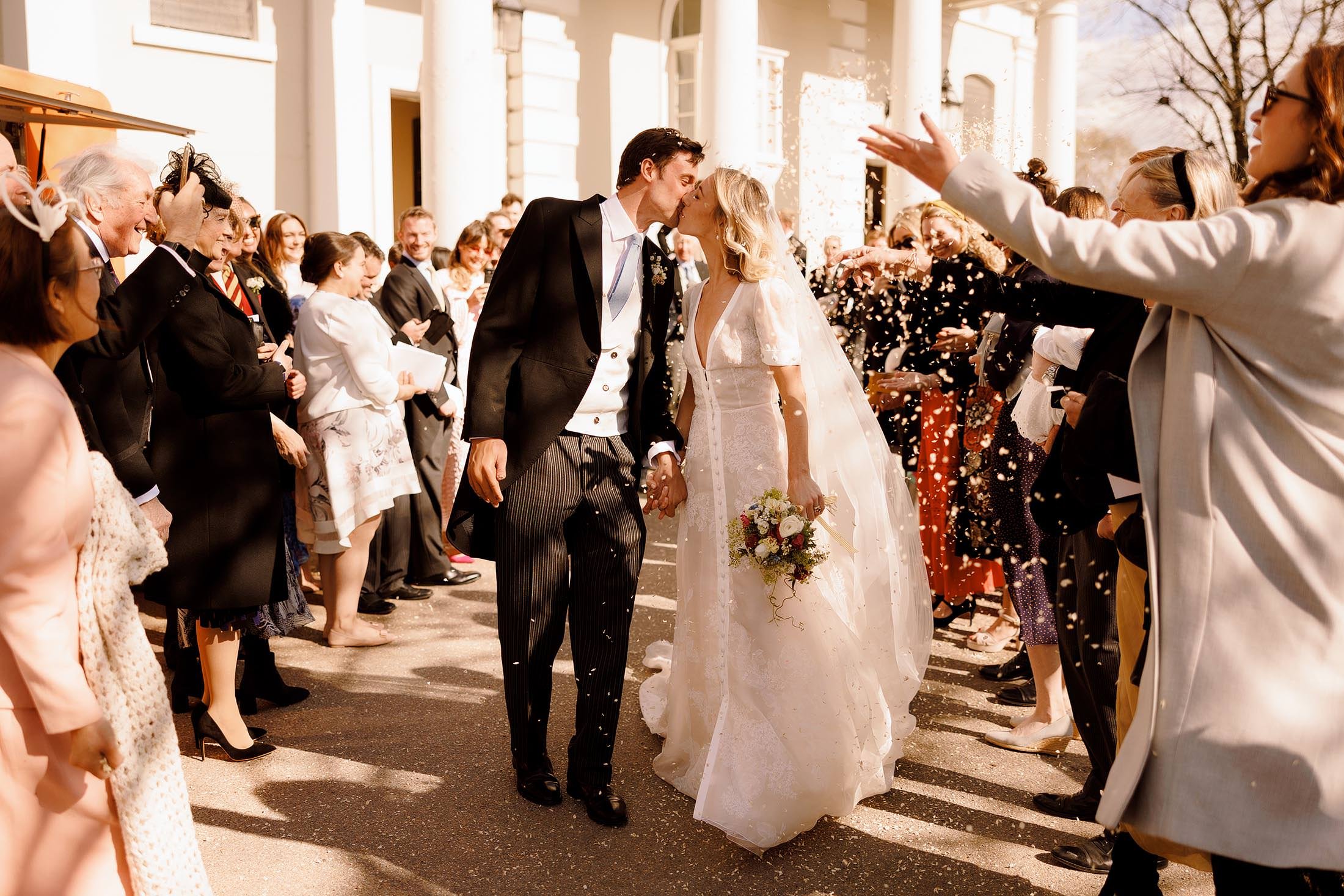 couple kiss during confetti at st mary's battersea london