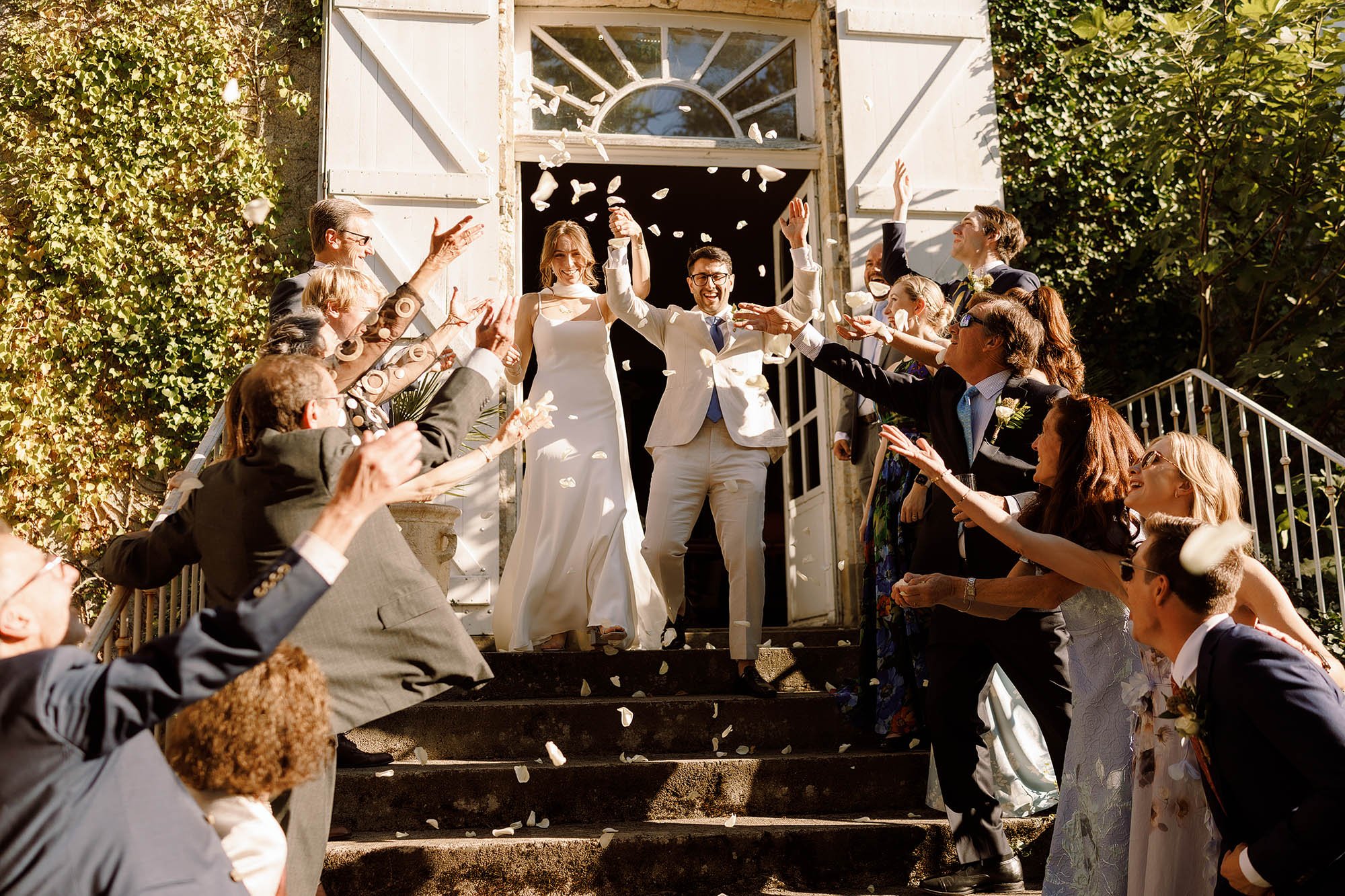 bride and groom confetti exit at chateau de lartigolle france