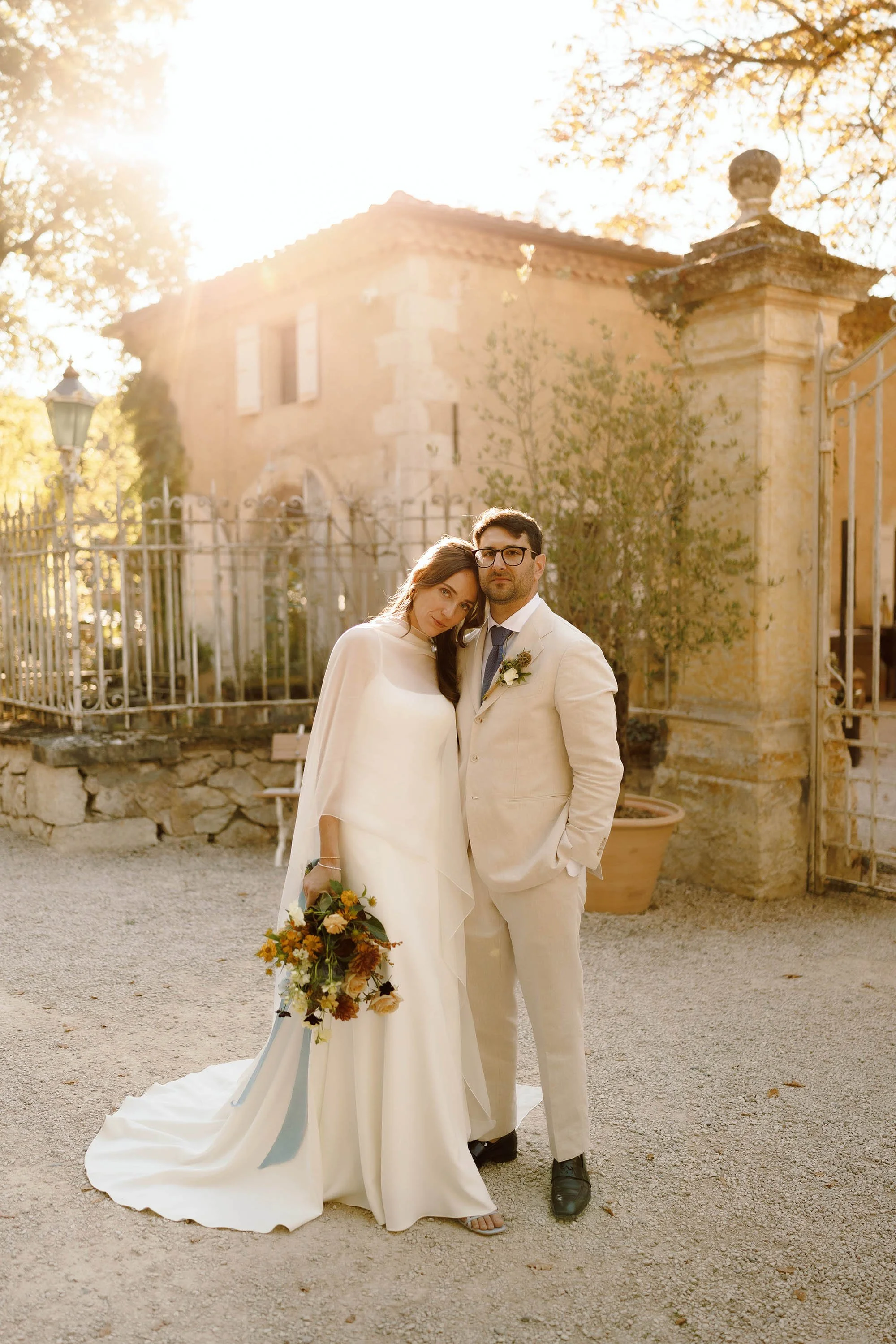 bride in jenny yoo dress and groom in cream suit