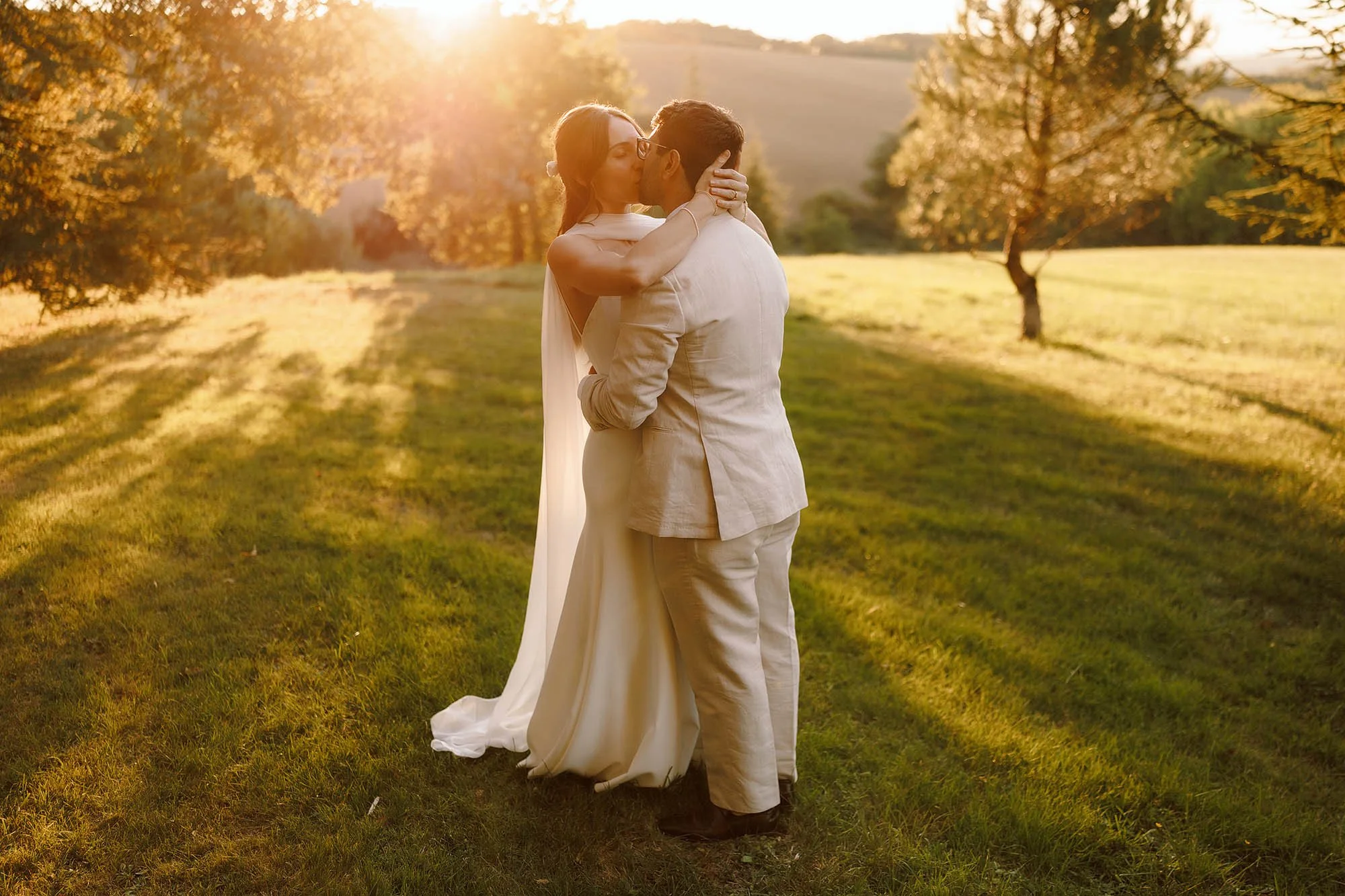 bride and groom kiss during sunset in the south of france