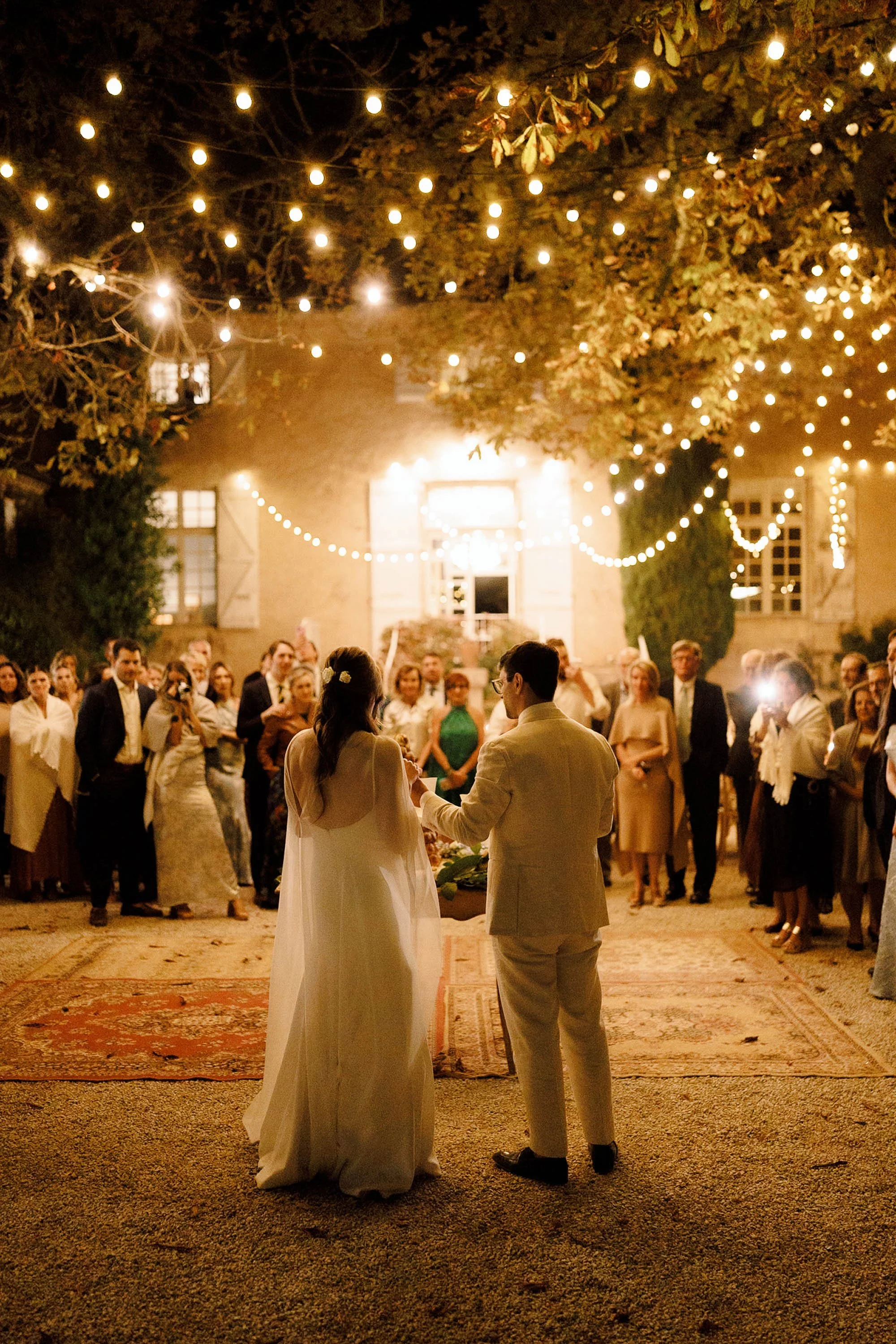 bride and groom deliver speech outdoors at chateau de lartigolle france wedding