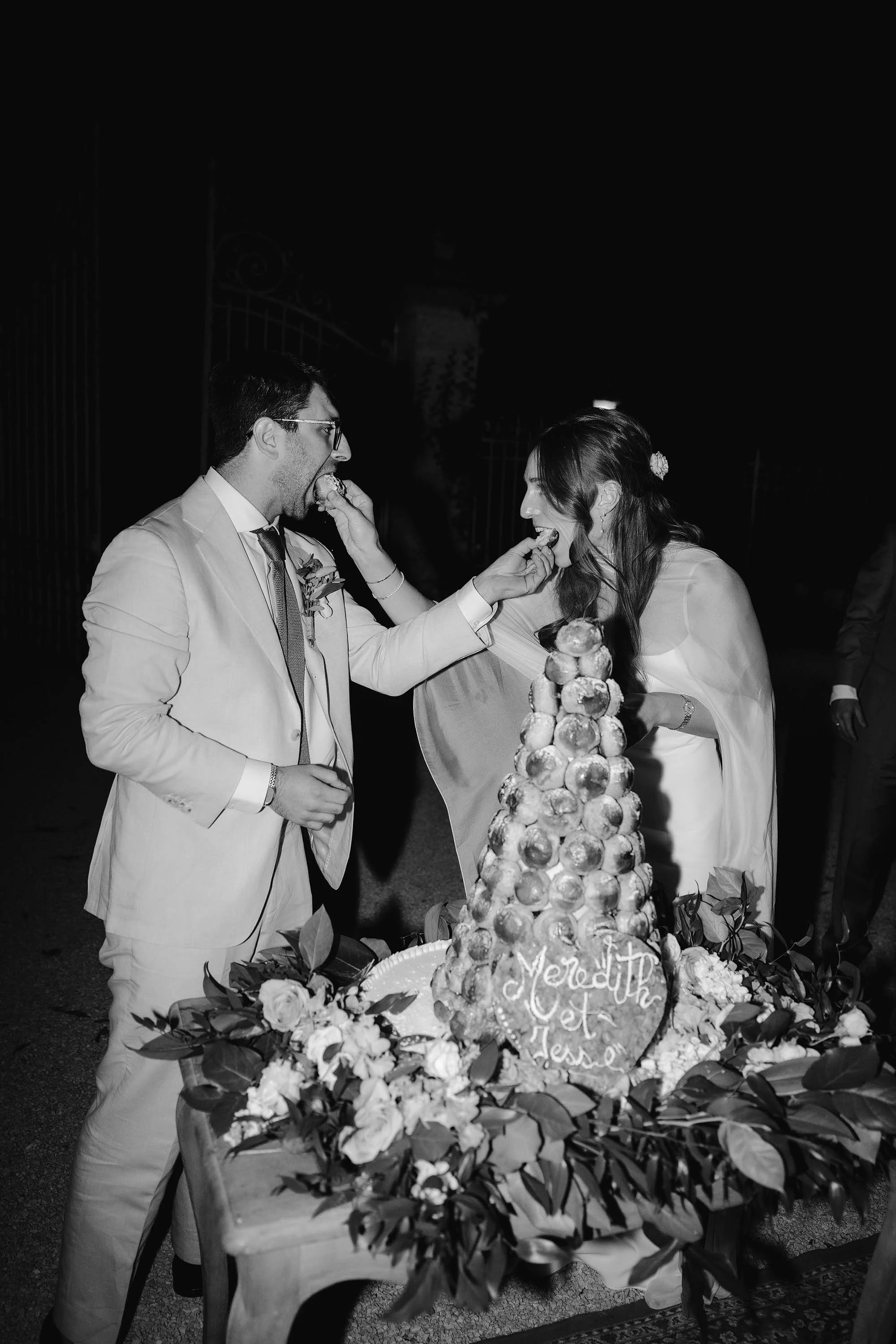 bride and groom feed each other croquembouche at south of france wedding