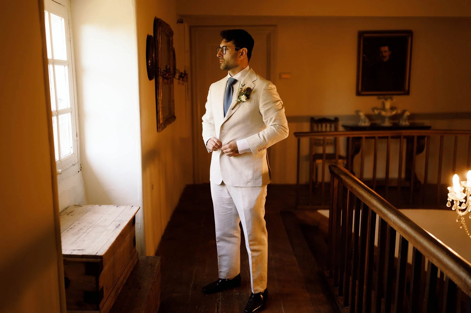 groom finishes getting ready at chateau de lartigolle wedding