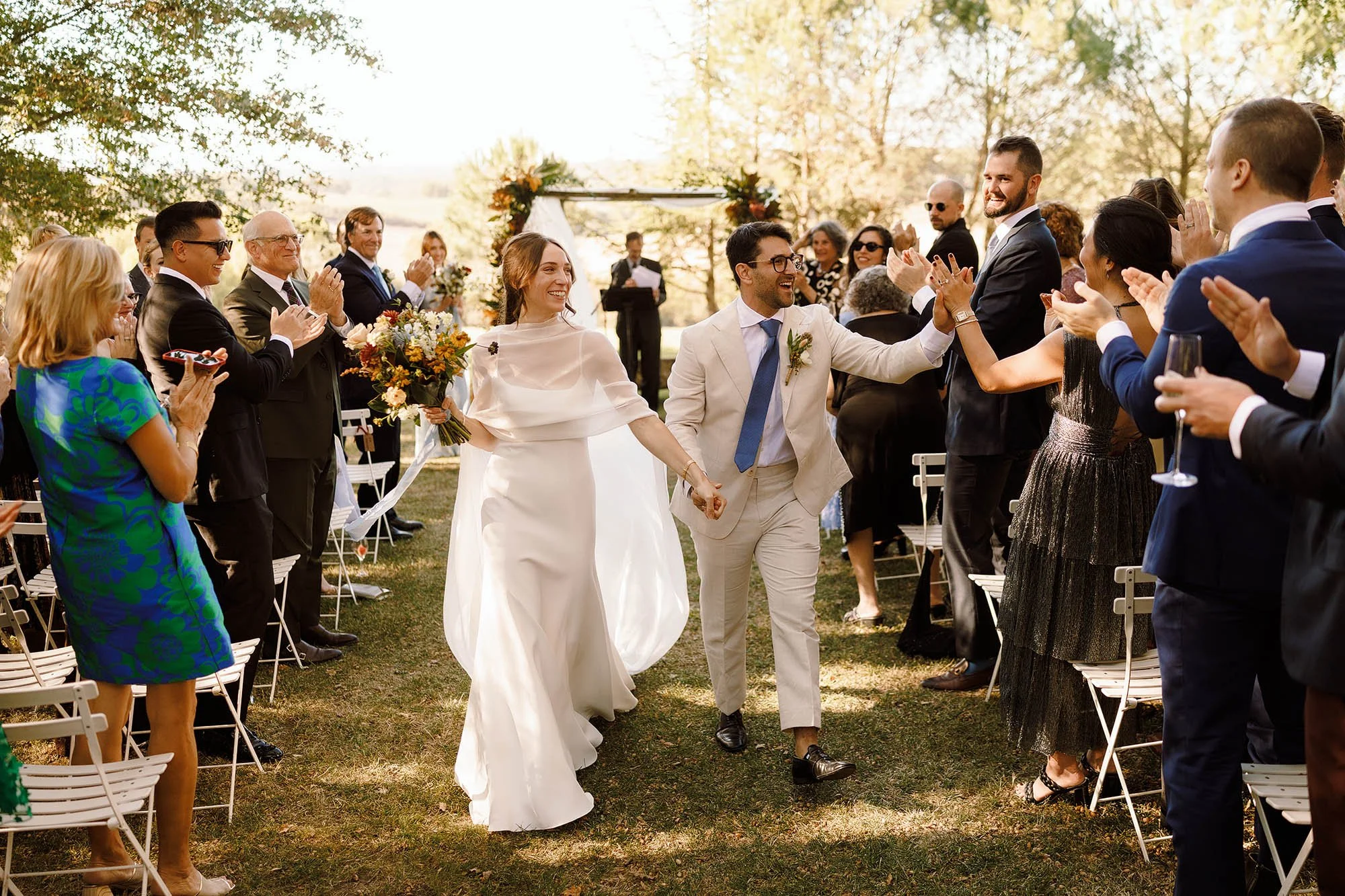 bride and groom walk down aisle smiling after ceremony in the south of france
