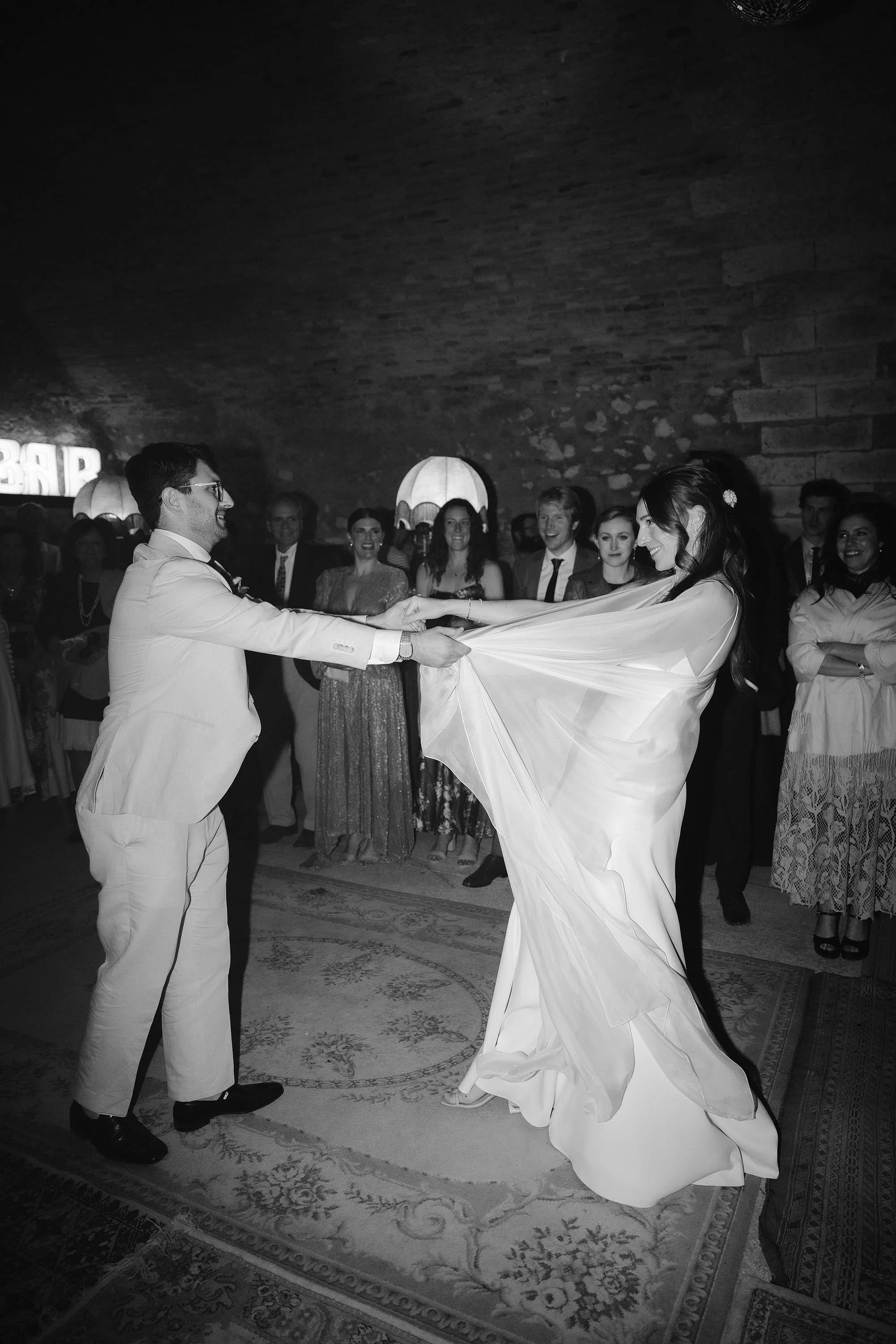 bride and groom do first dance in rave cave