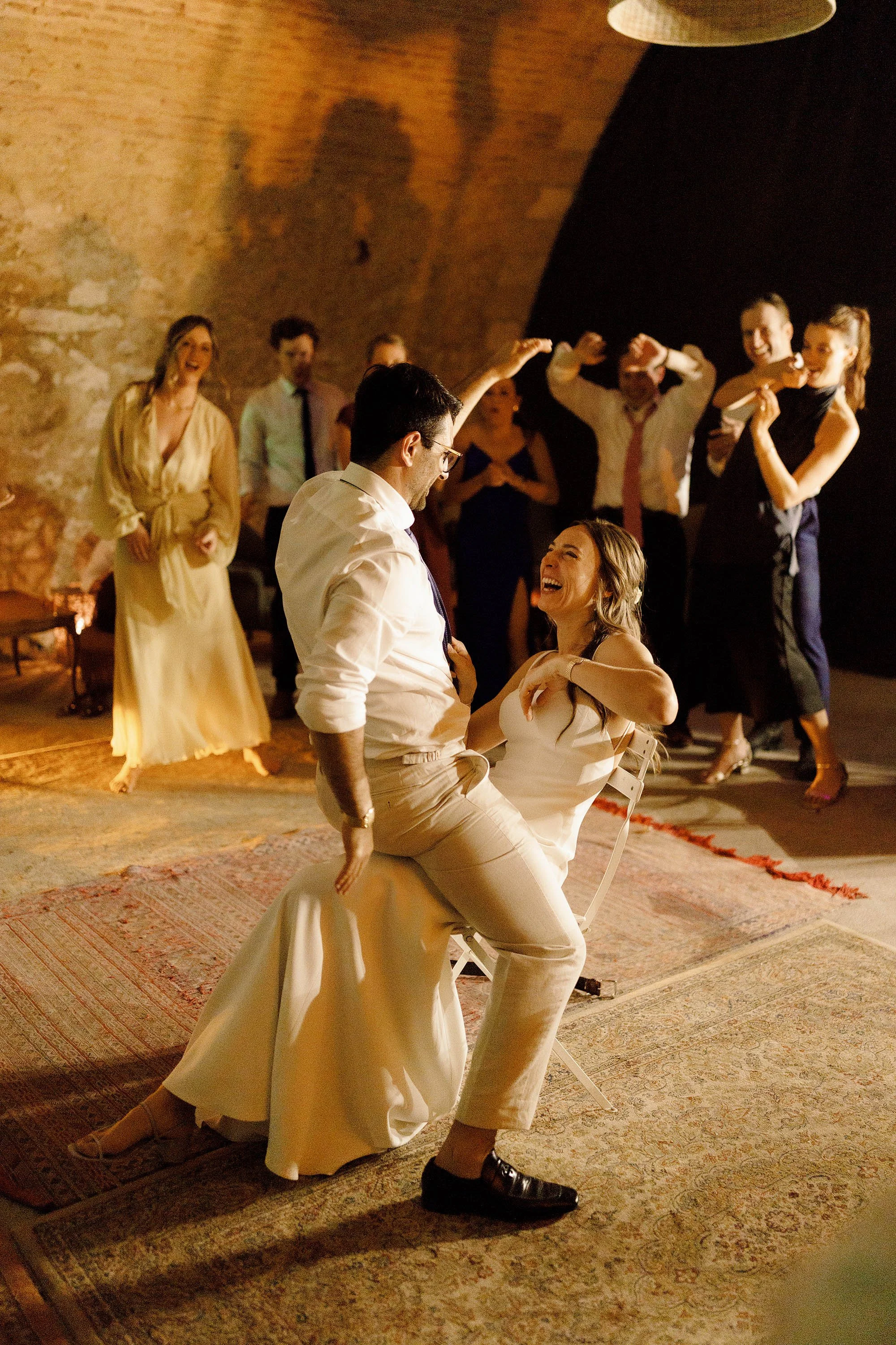 groom gives bride a lap dance during wedding evening