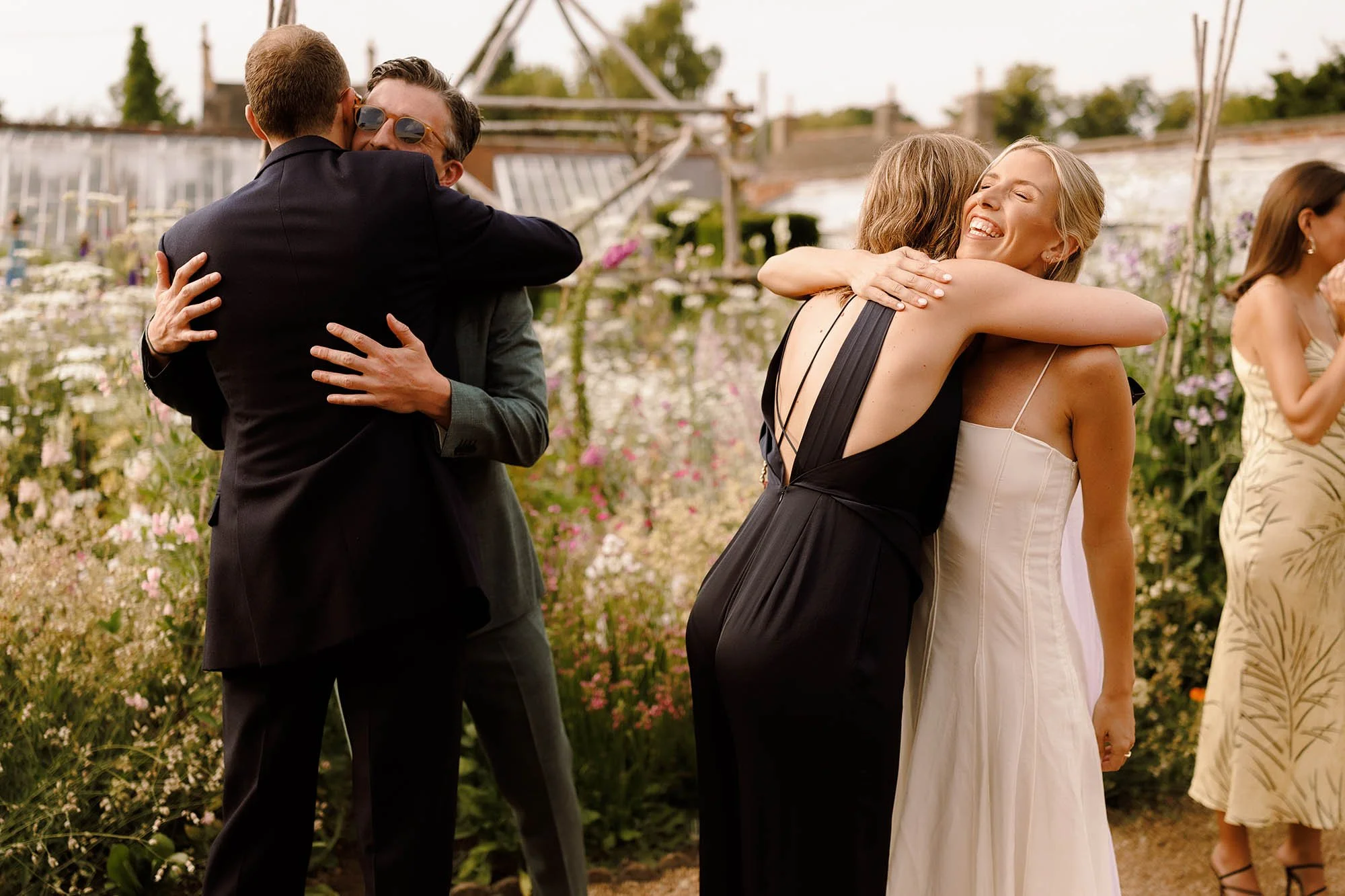 bride and groom greet guests at nevill holt wedding