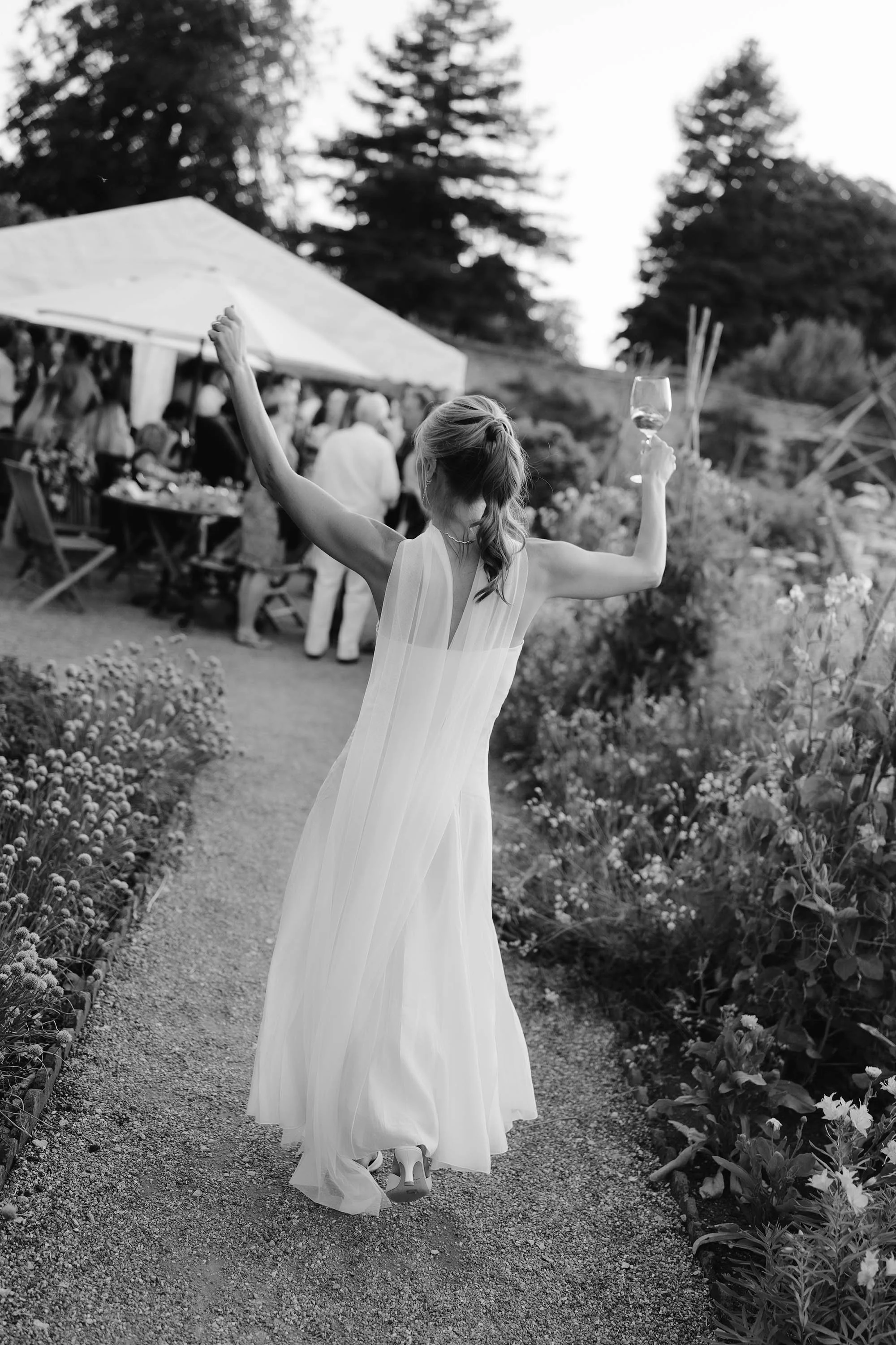 bride dances outside during pre-wedding cocktail event at nevill holt estate wedding