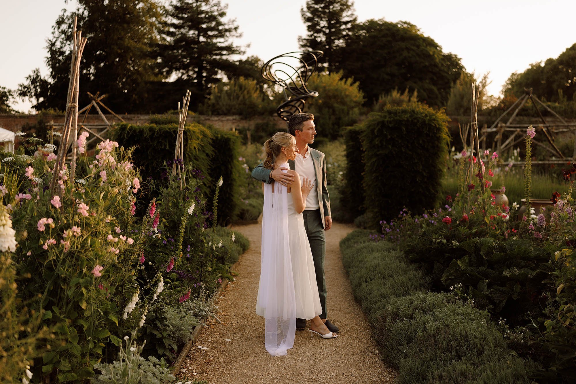 bride and groom during sunset at nevill holt estate italian garden
