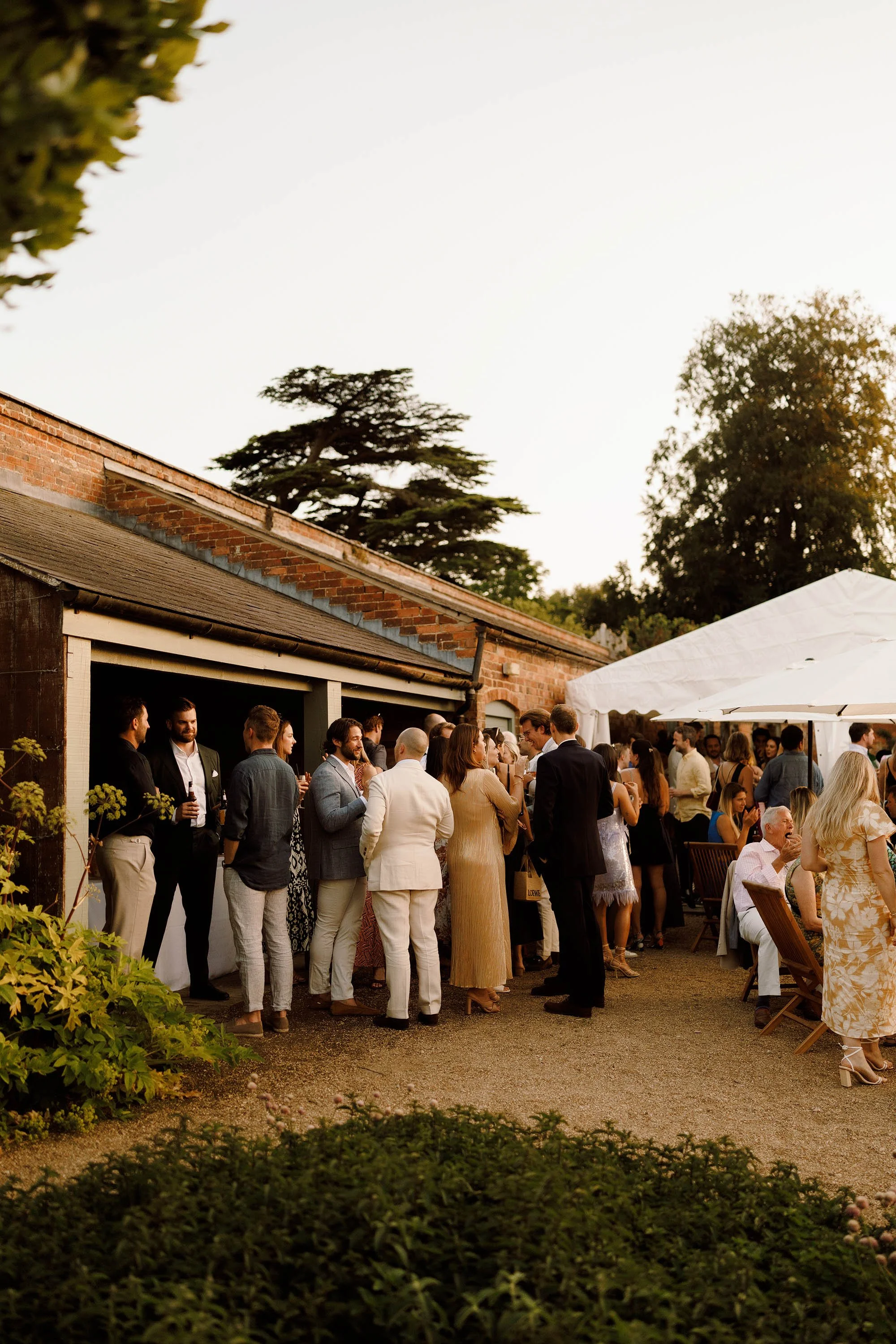 guest mingle during evening cocktail event night before wedding