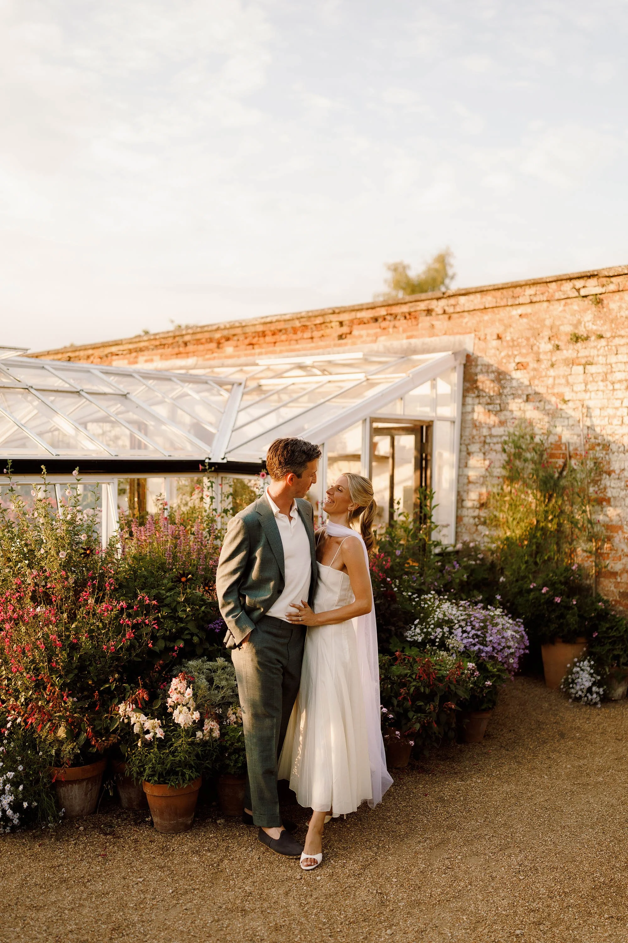 couple portraits at sunset in nevill holt estate wedding with bride in halter neck scarf