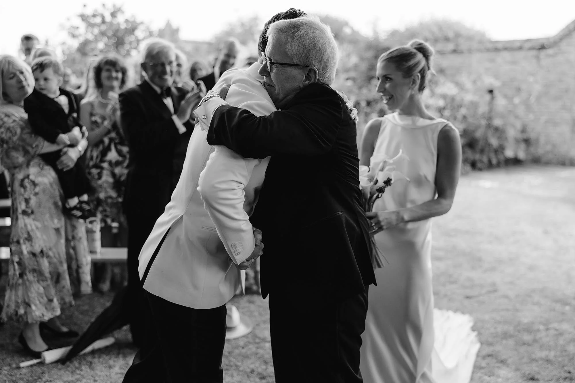 brides father gives her away at outdoor ceremony