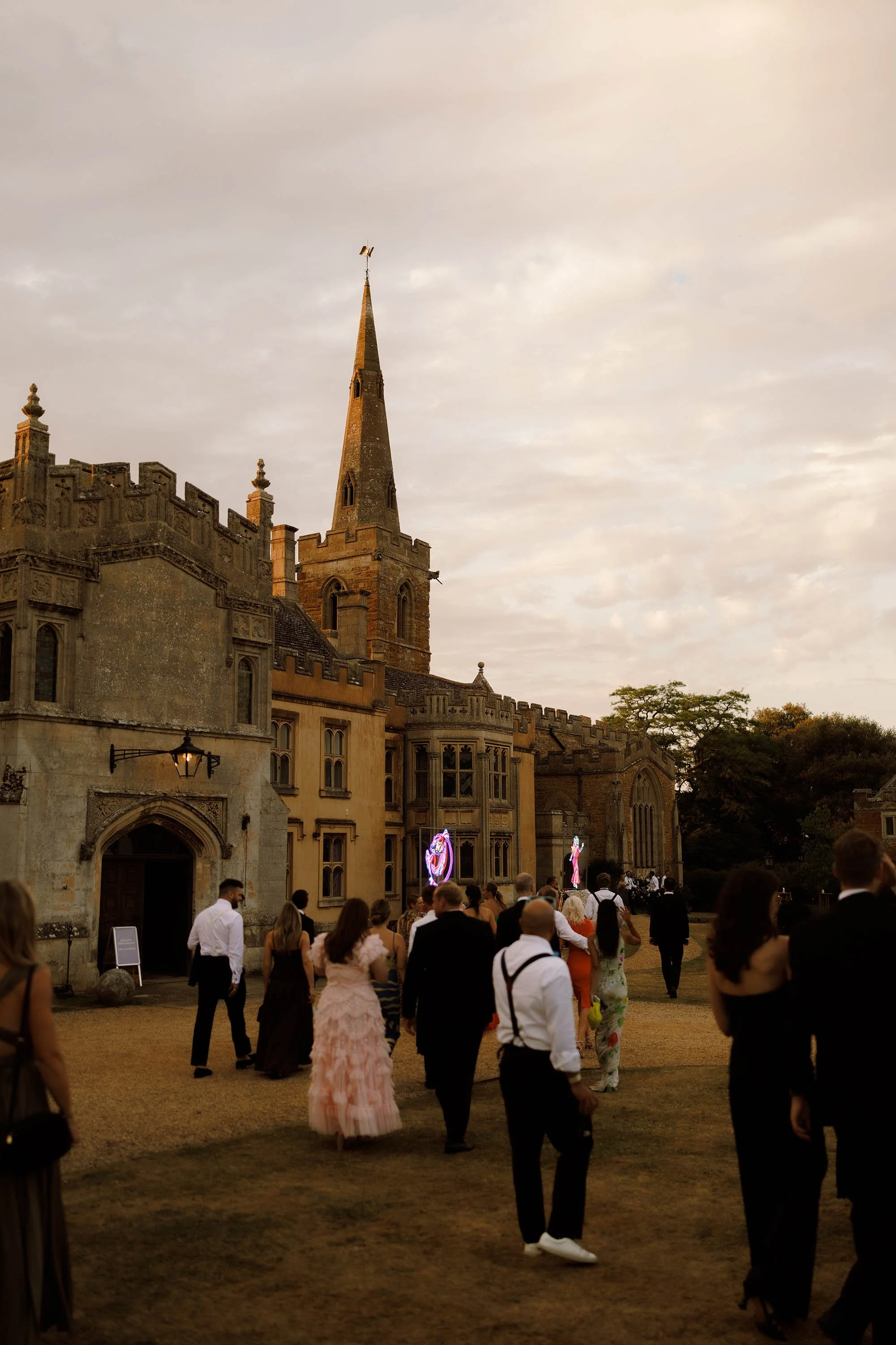guests walk towards dancefloor venue at nevill holt estate wedding