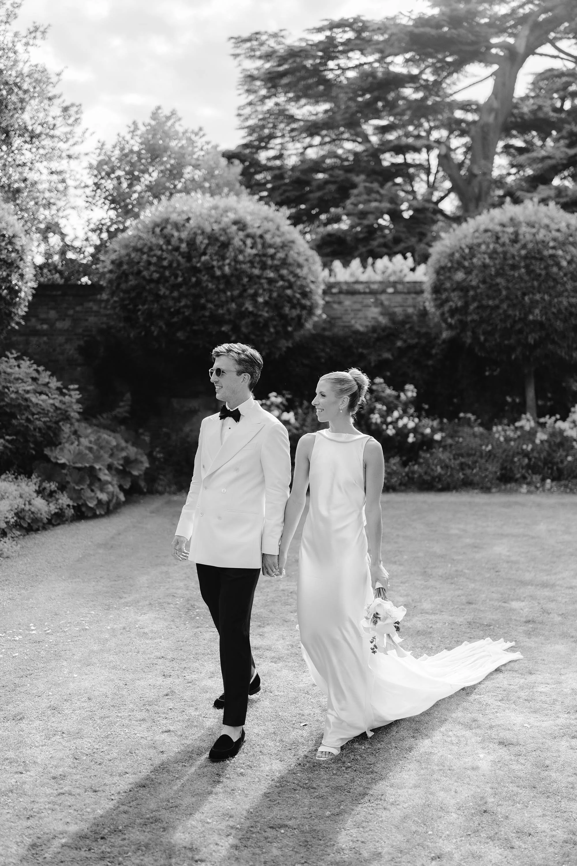 couple portraits with groom in white tuxedo and bride in danielle frankel