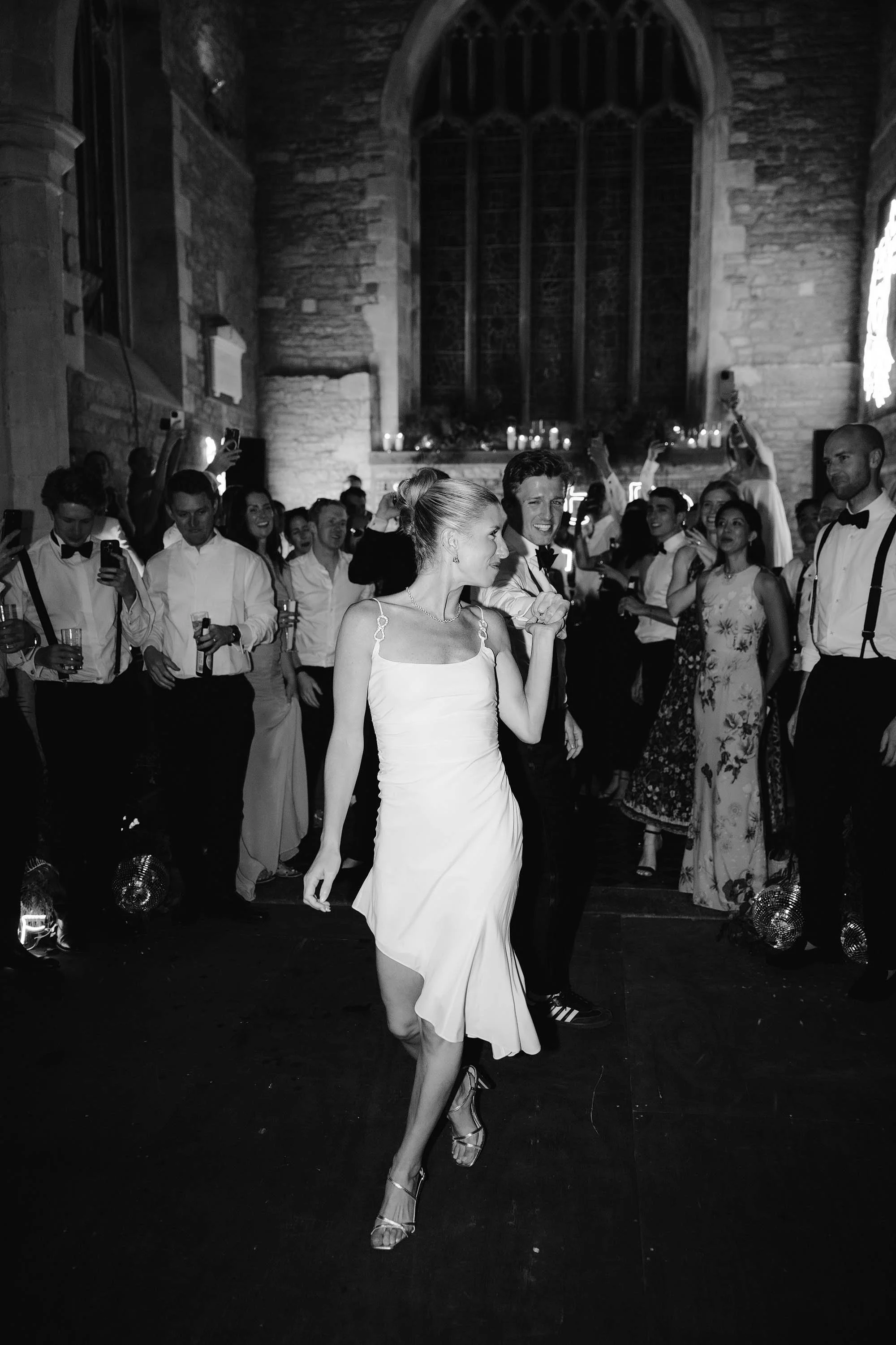 couple do first dance in old church at nevill holt estate
