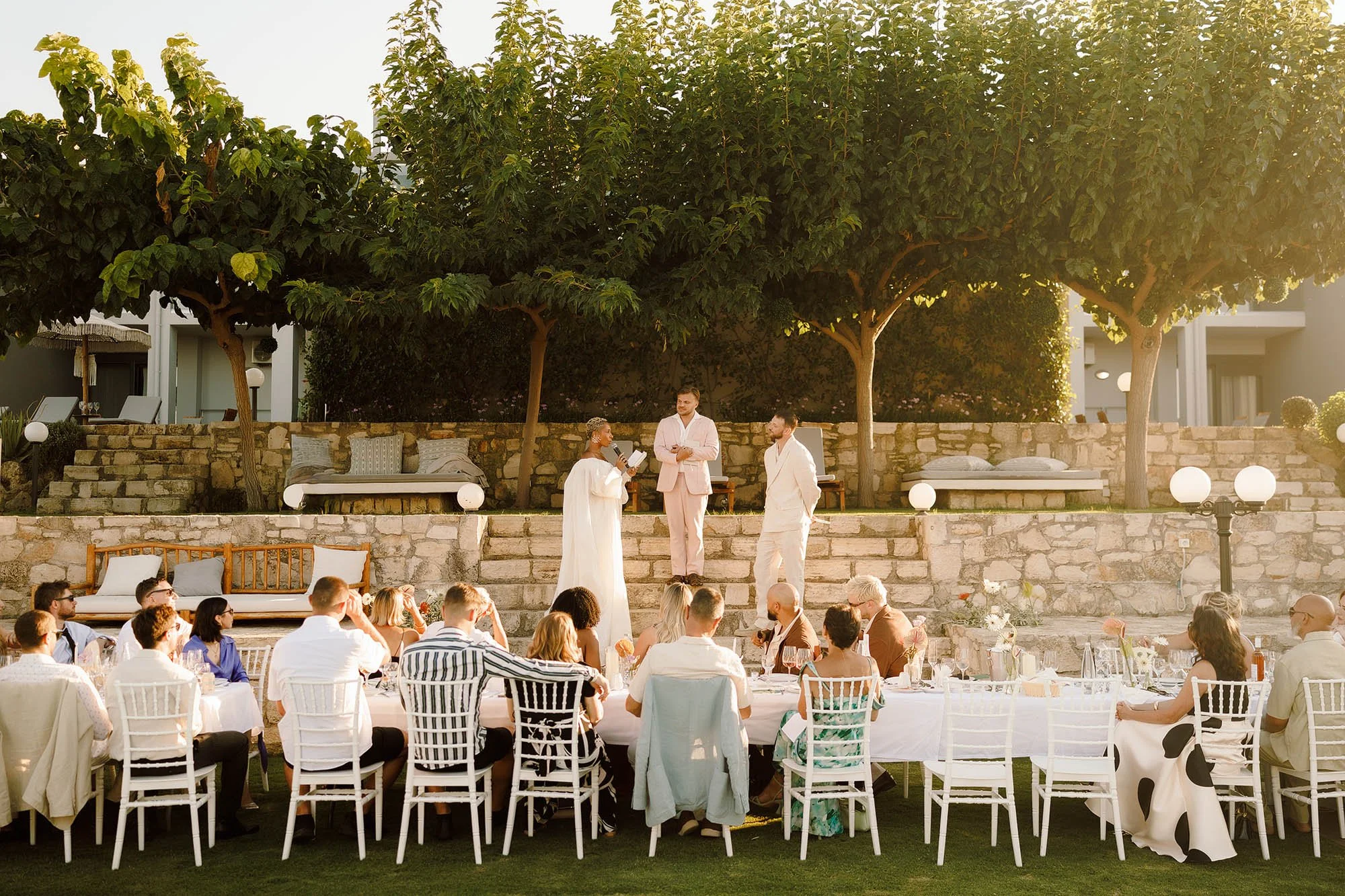 speeches in front of long dinner table at chania greece wedding