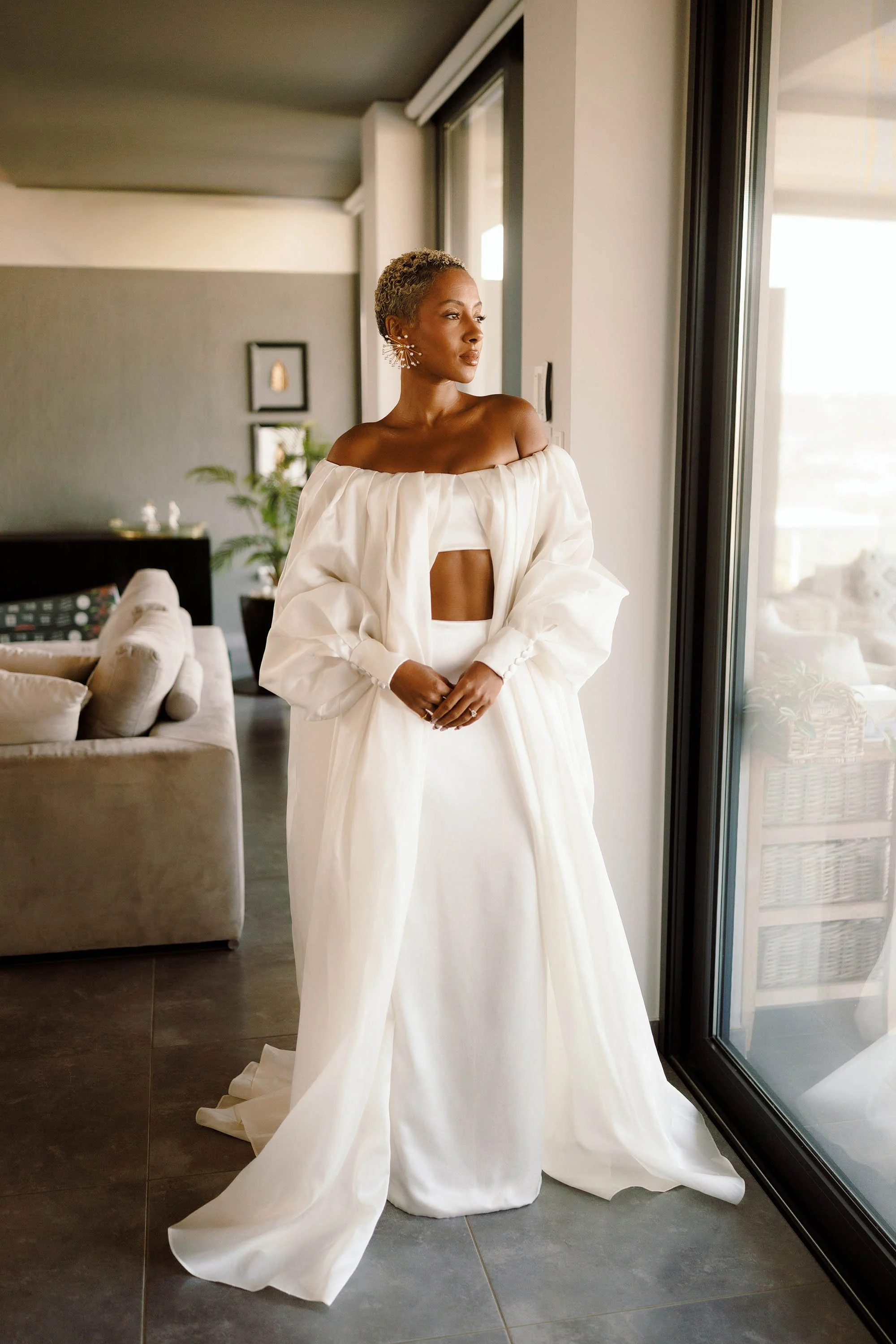 bride poses in stylish bespoke wedding dress