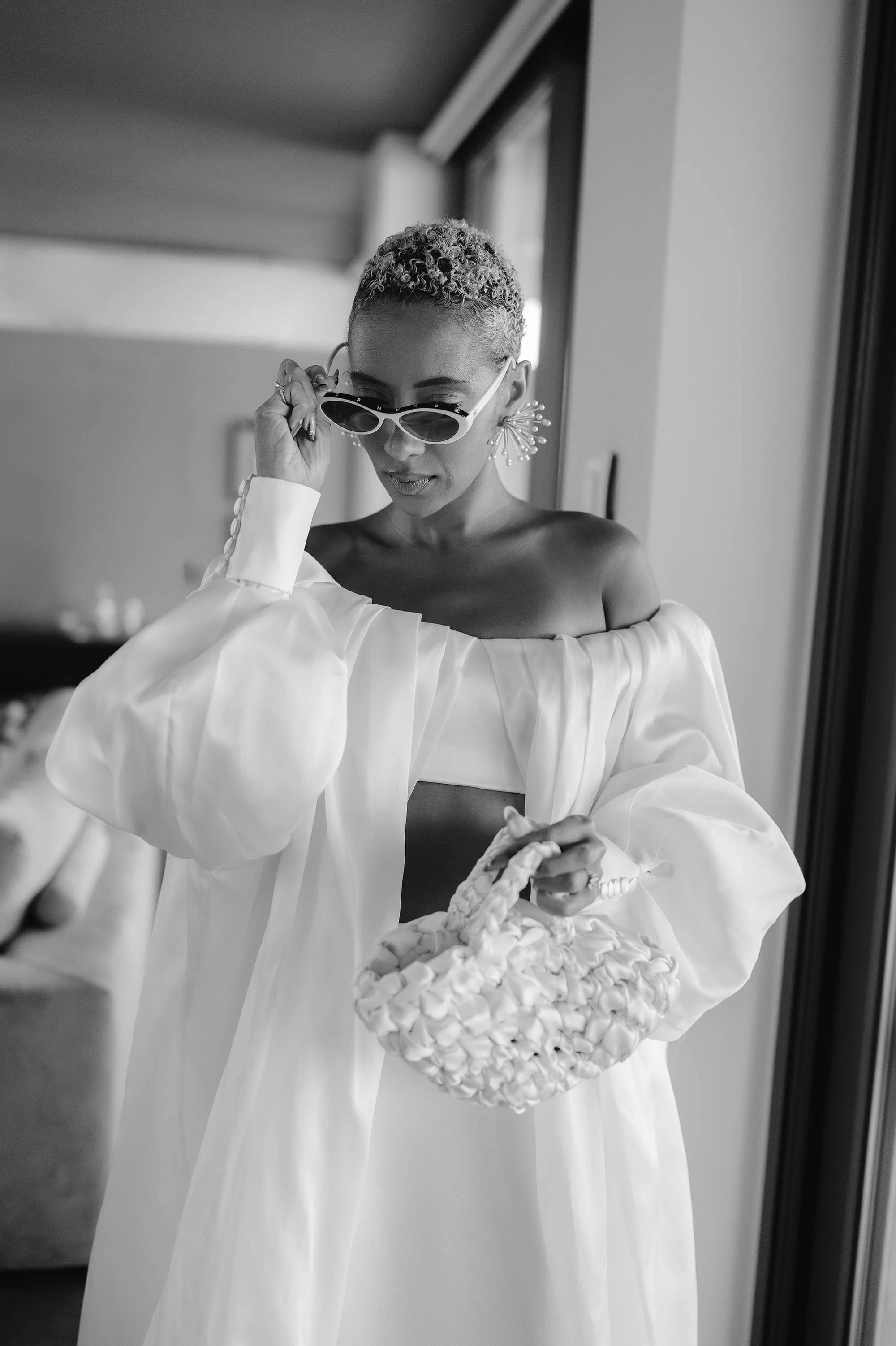 bride poses in prade sunglasses at crete wedding