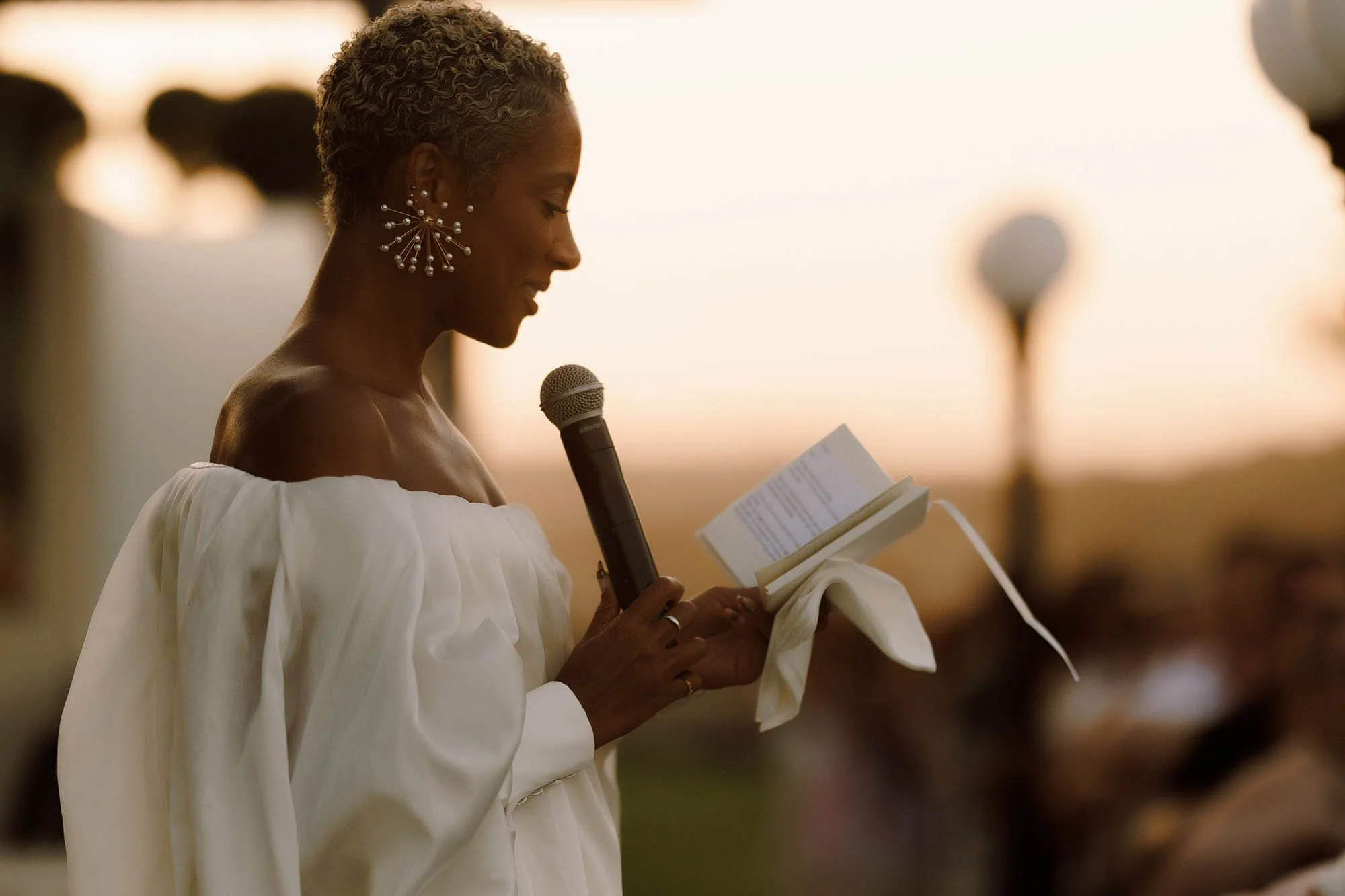 bride delivers speech at sunset for Crete destination wedding