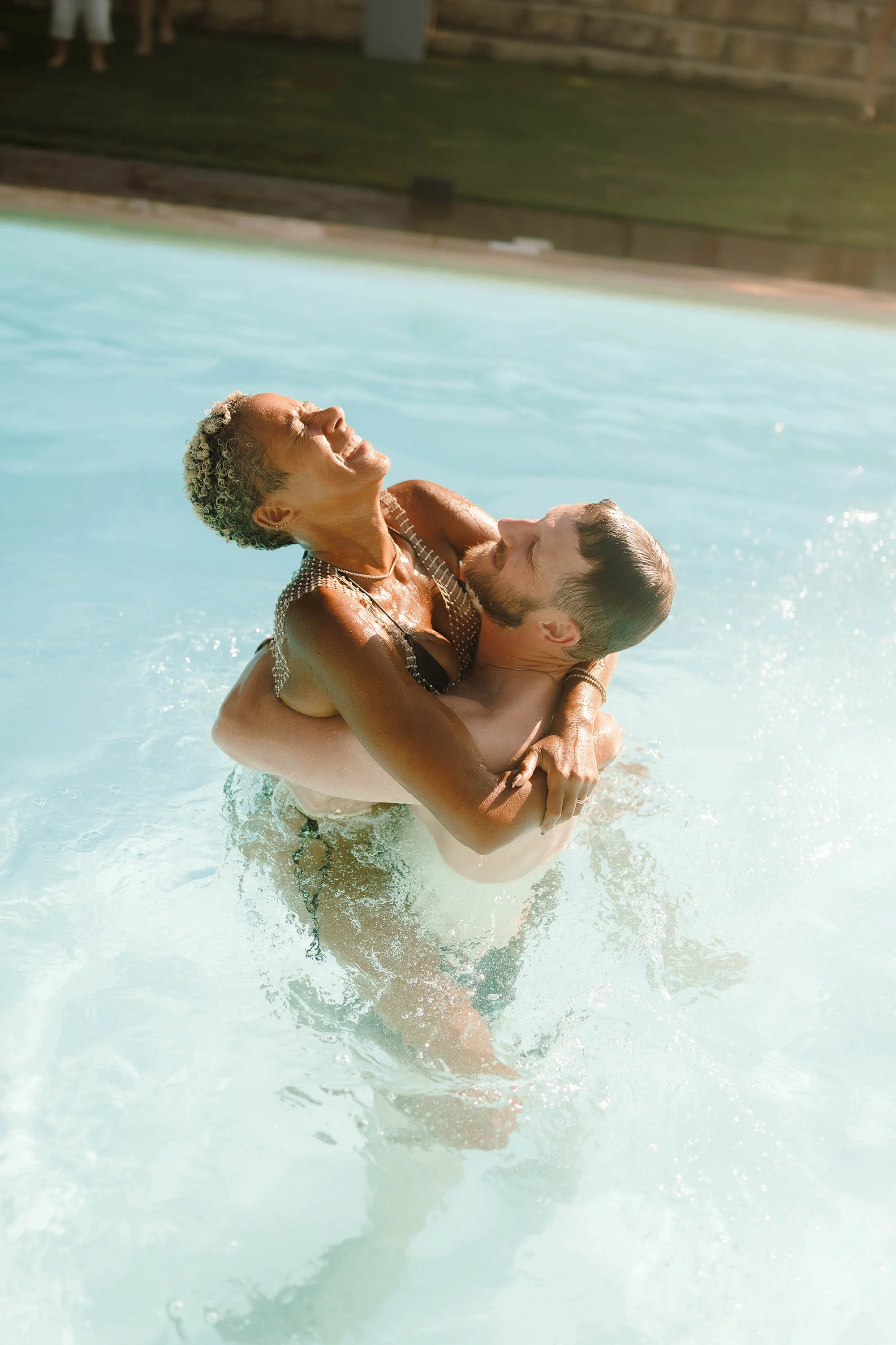 bride and groom enjoy pool party for crete destination wedding