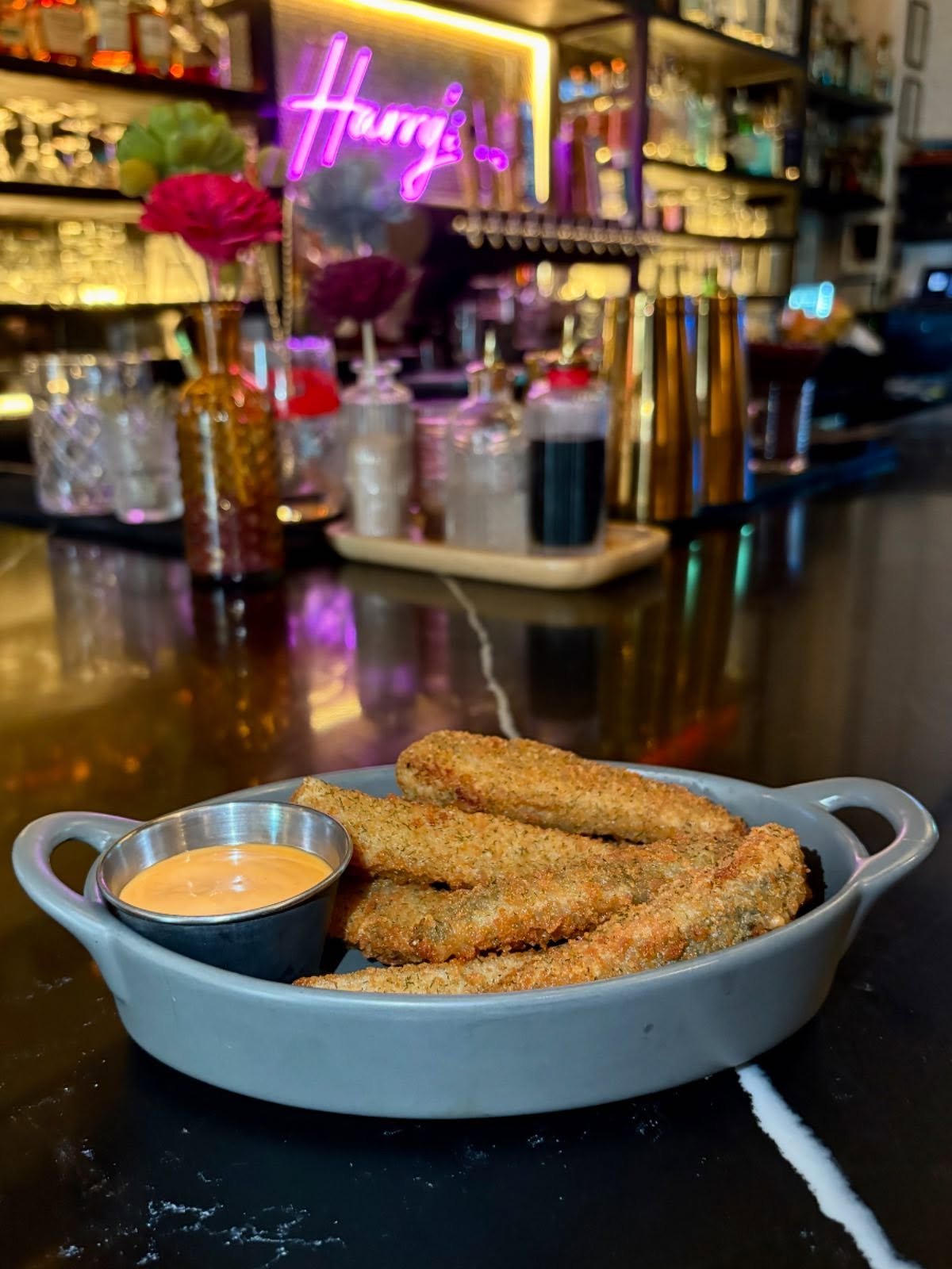 Crisp, briny speared pickles &mdash; the perfect bite between sips! Grab yours during Happy Hour, 4&ndash;6PM daily. Pair with a martini or highball and make it a moment.