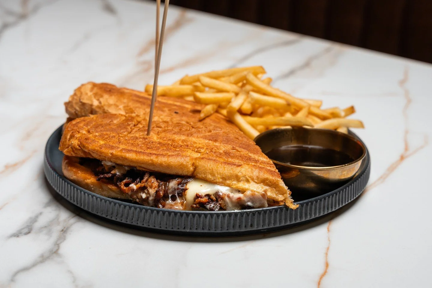 🥩 Steak Sandwich
Shaved ribeye, gruyere, caramelized onions, and garlic aioli on a roll served with beef jus. Savory. Melty. Packed with flavor.

The kind of sandwich that requires two hands and zero distractions.
Tag your steak-loving friend and ma