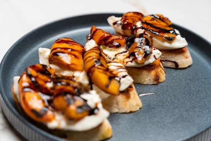 This is your sign to order something &ldquo;for the table&rdquo;&hellip; and not share it 🍑

Grilled stone fruit, creamy cheese, and that balsamic drizzle that ties it all together. Sweet, savory, and honestly kinda addictive.

Trust us, you&rsquo;r