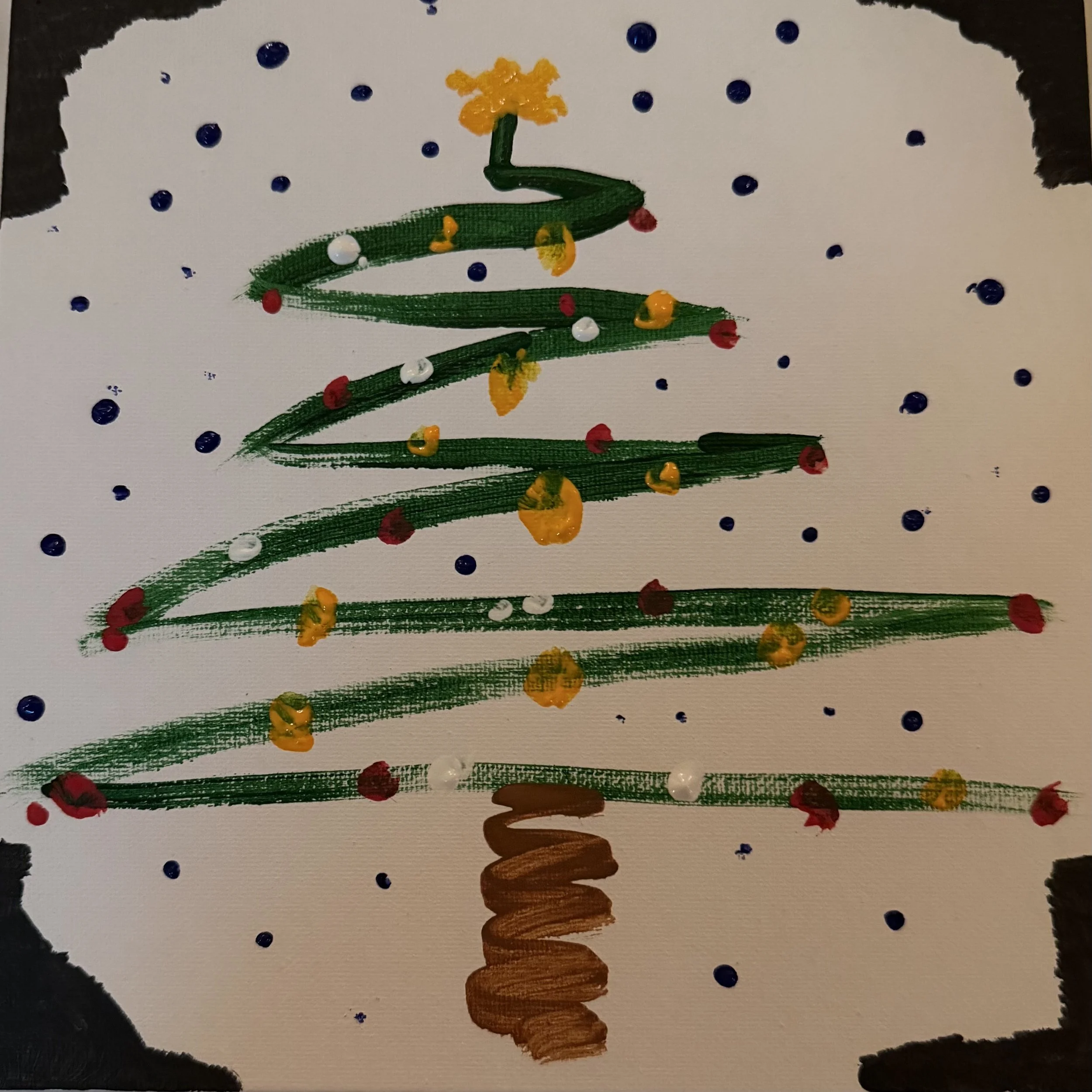 Children's drawing of a Christmas tree with green lines, decorated with yellow, red, and white dots, topped with a yellow star, against a white background with blue dots and black borders.
