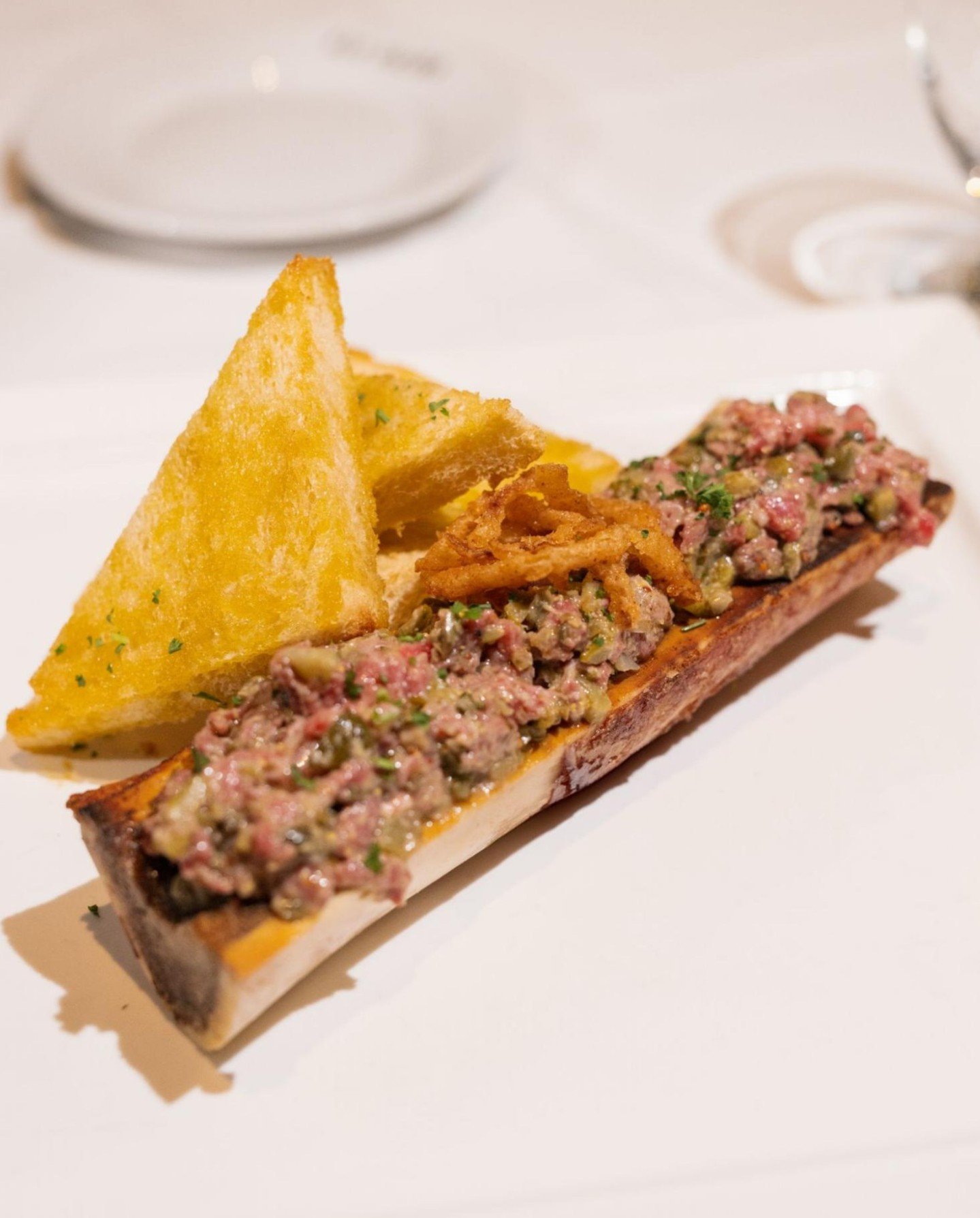 Wagyu Steak Tartare &amp; Bone Marrow.  Velvety American wagyu with brioche to scoop every last bite. It&rsquo;s primal, luxurious, and made to be savored.