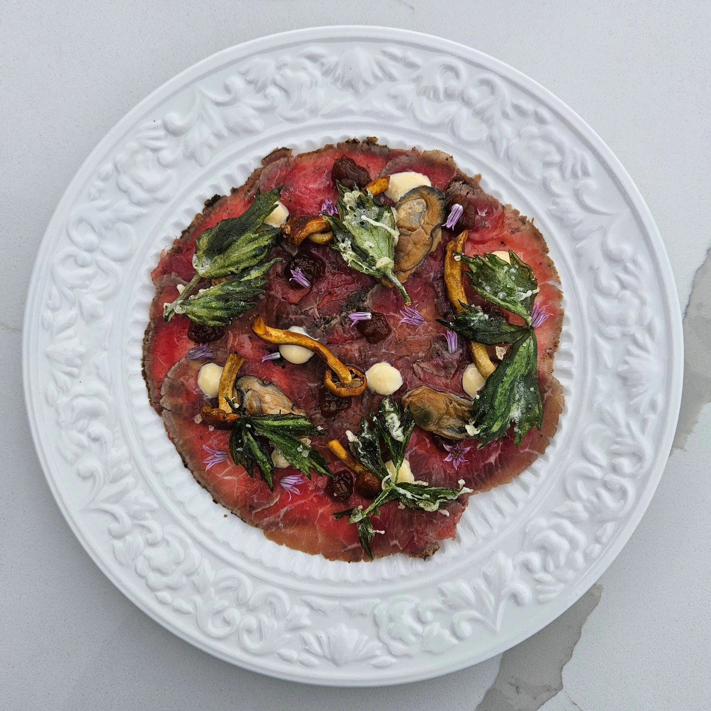 Surf &amp; Turf Carpaccio

smoked breton oysters, maritime beef culotte, mushroom ash, pickled porter river chestnut mushrooms, lovage tempura, we'koqma'q oyster caramel

an absolute flavour bomb in every bite. 😍

$29