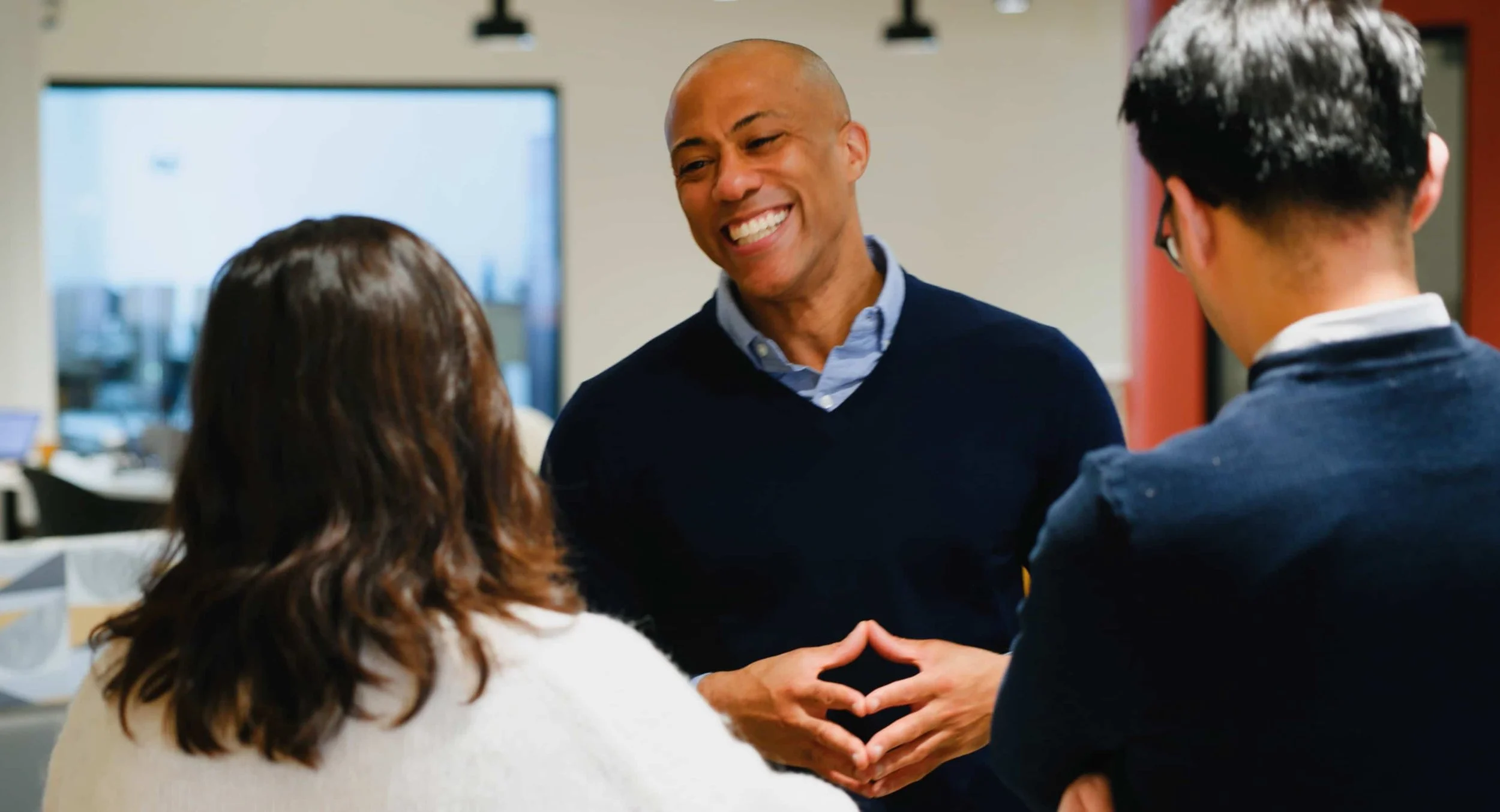 corporate team members having a collaborative conversation in office environment