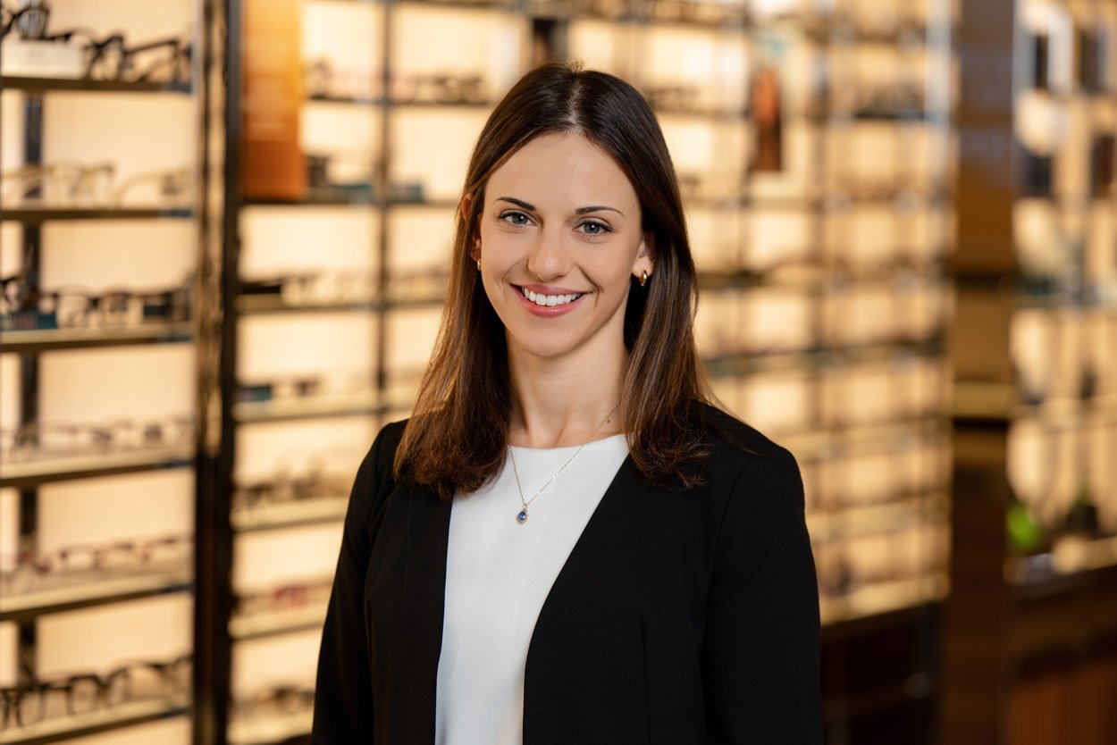Professional environmental portrait of an optometrist photographed inside her Boston-area optical practice for corporate branding and marketing.